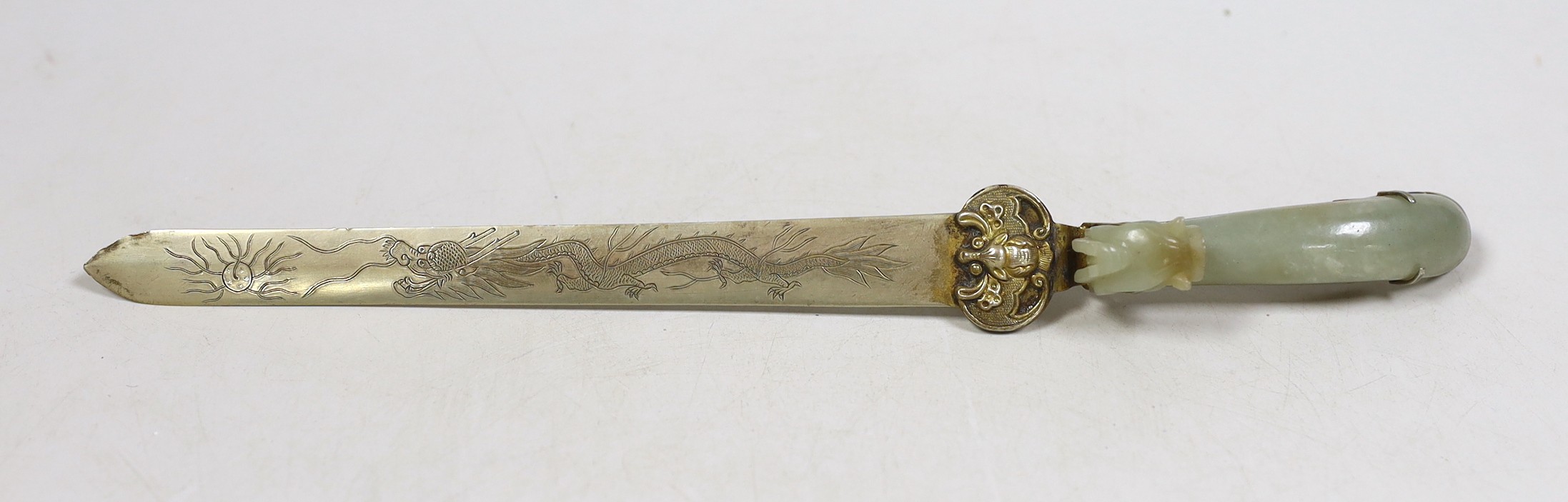 A Chinese celadon jade belt hook handled paperknife, the 19th century belt hook 8.2 cm long, total length 26.5 cm                                                                                                           