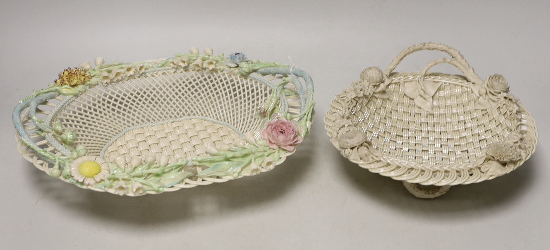 A Belleek coloured basket and similar smaller basket, large coloured basket 29cms wide                                                                                                                                      