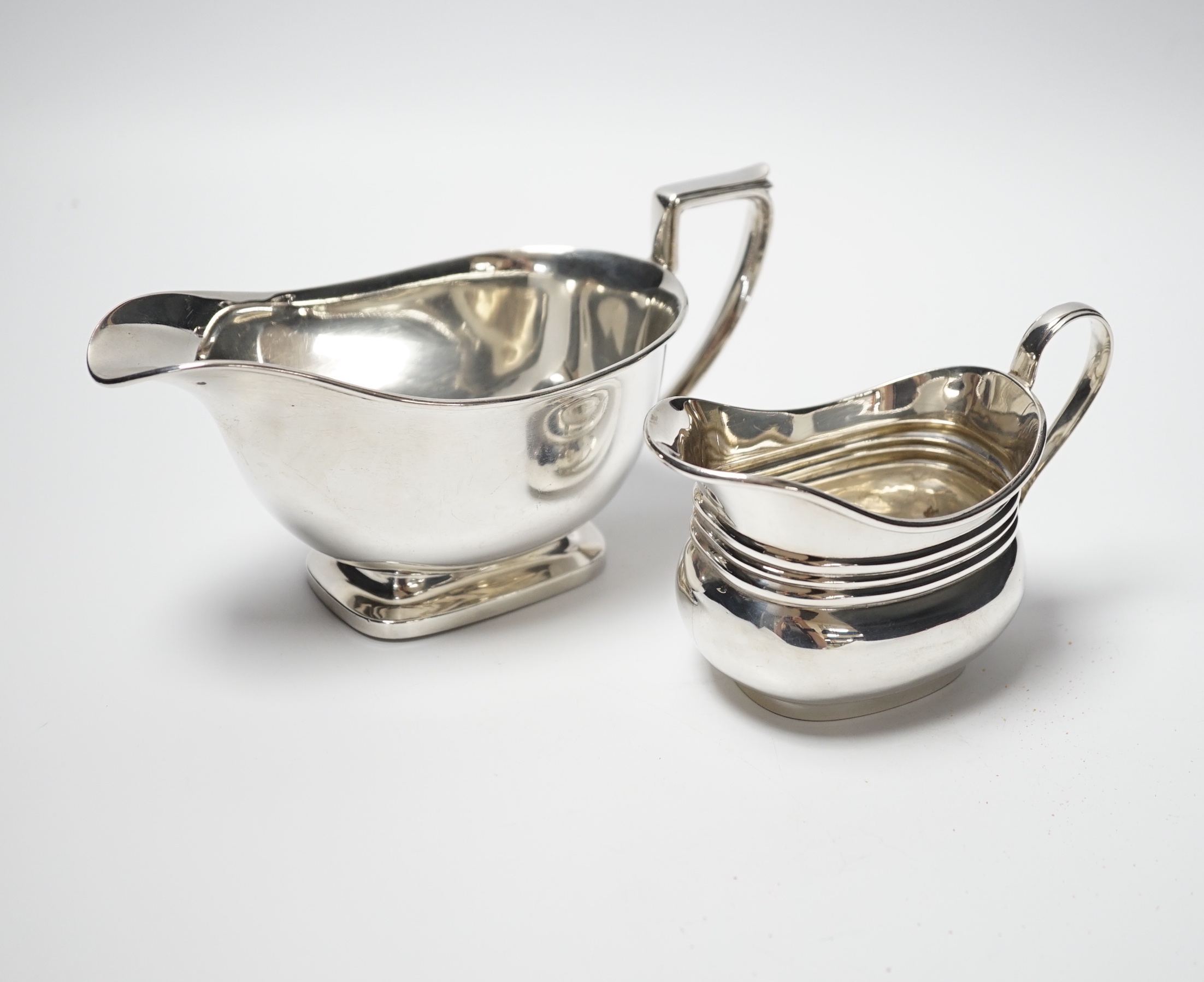 A George VI silver sauceboat, Birmingham, 1947 and a silver cream jug, marks rubbed, 10.5oz.                                                                                                                                