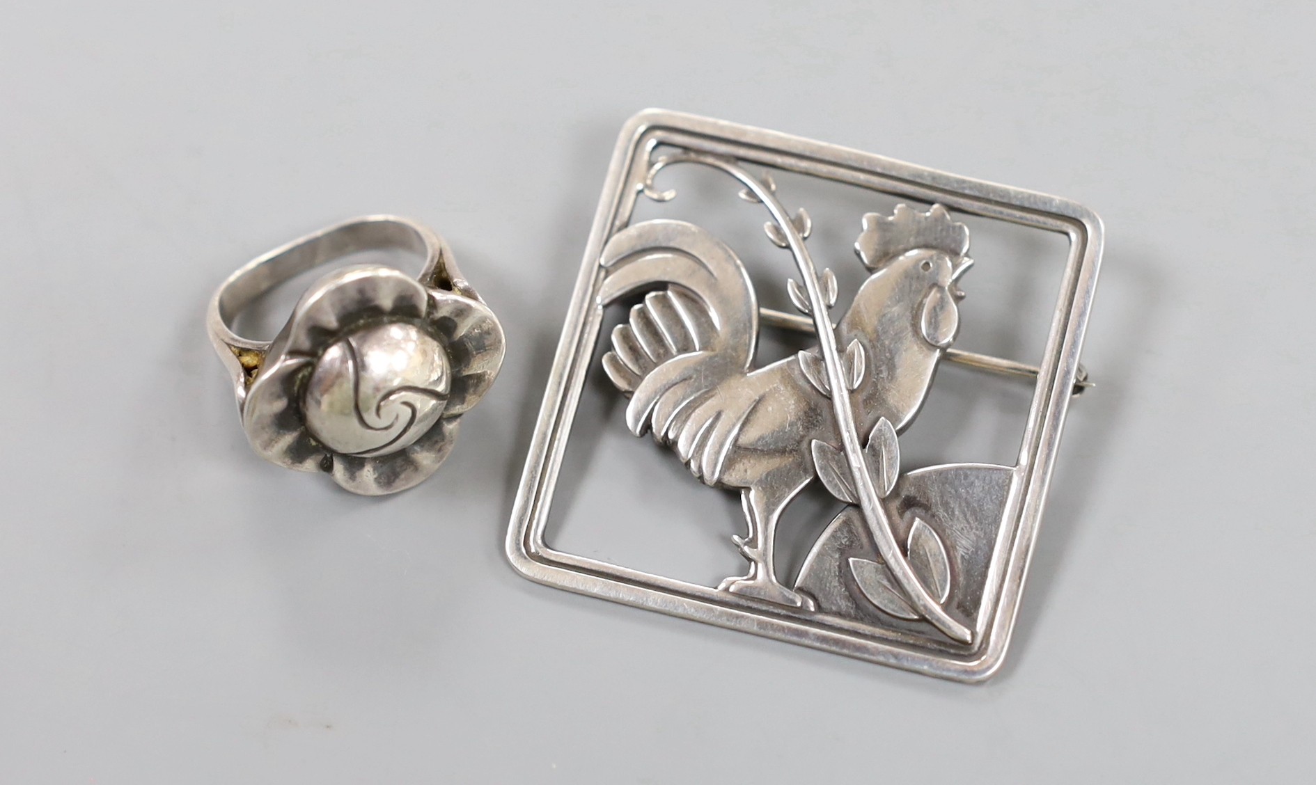 A Georg Jensen sterling square cockerel brooch and frond, no. 276, 37mm and a Jensen style flower head ring, size G.                                                                                                        
