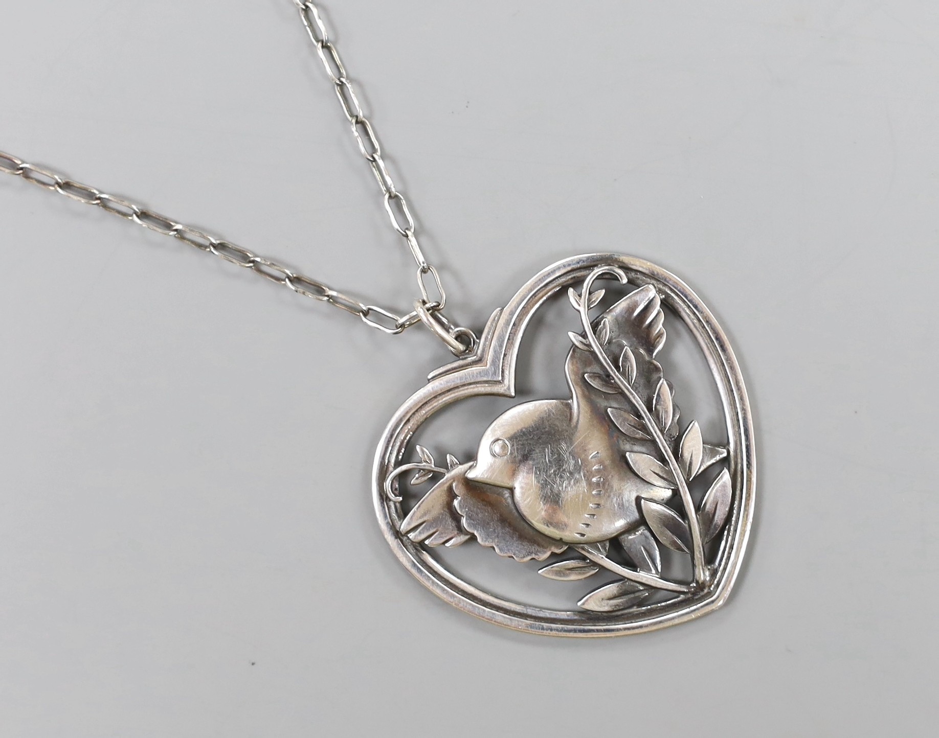 A Georg Jensen sterling 'Robin and frond' heart shaped pendant necklace, no. 97, 36mm.                                                                                                                                      