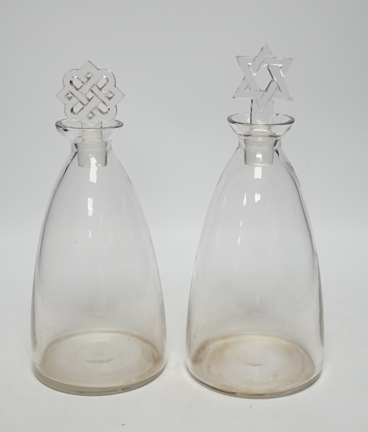 Two R. Lalique decanters, one with a Celtic knot stopper, the other the Star of David, tallest 27cm high (mark to base)                                                                                                     