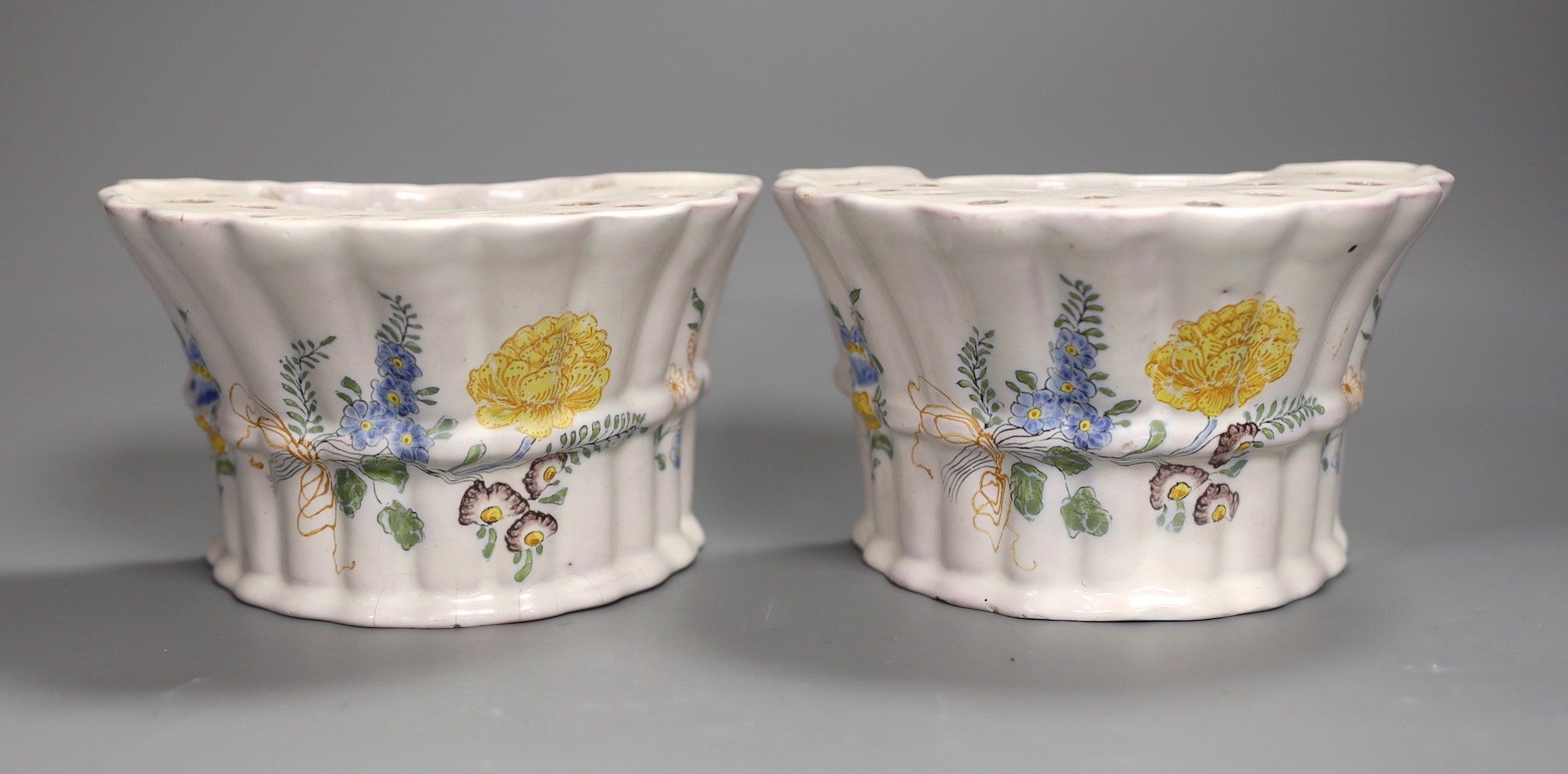 A pair of German faience flower decorated bough pots, late 18th century, 15.5cm wide                                                                                                                                        