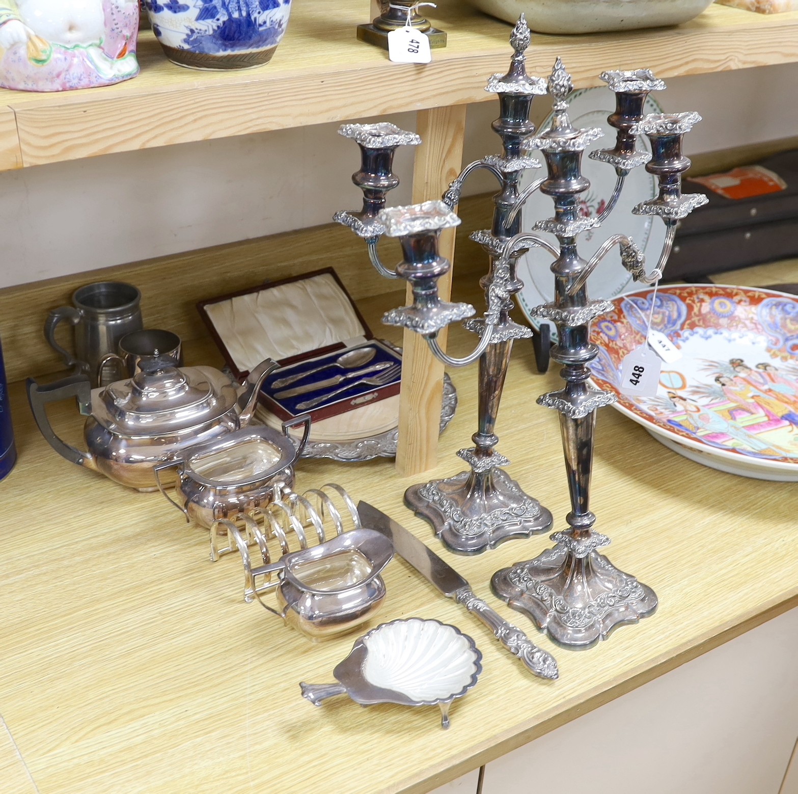 Assorted plated wares including a pair of three light candelabra, 52cms high                                                                                                                                                