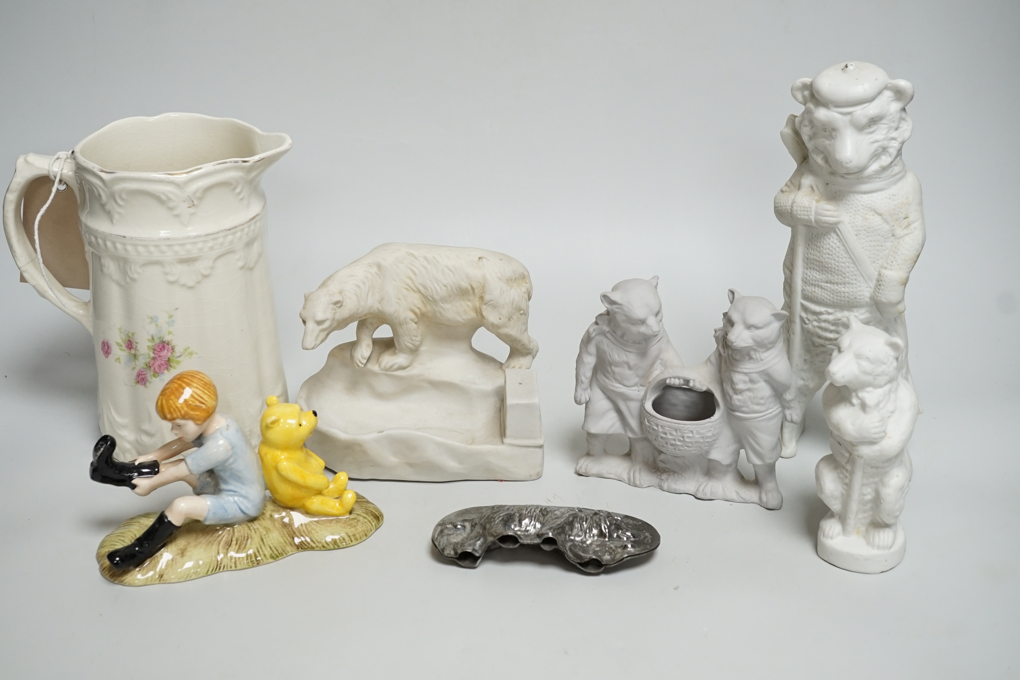 Four early teddy bear fairings, a Royal Doulton Christopher Robin and Pooh bear, a teddy bear chocolate mould and a jug with sporting teddy bears                                                                           