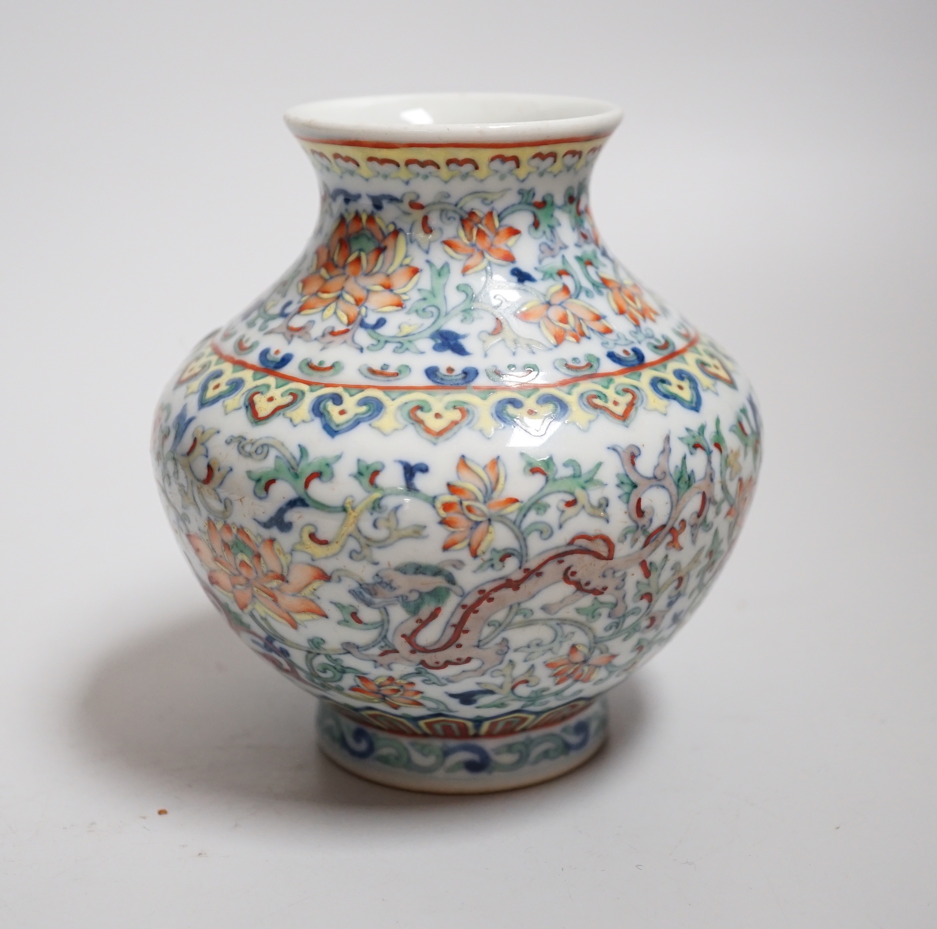 A small Chinese doucai jar, decorated with dragons and lotus flowers, housed in a fitted case, 12.5cm high                                                                                                                  