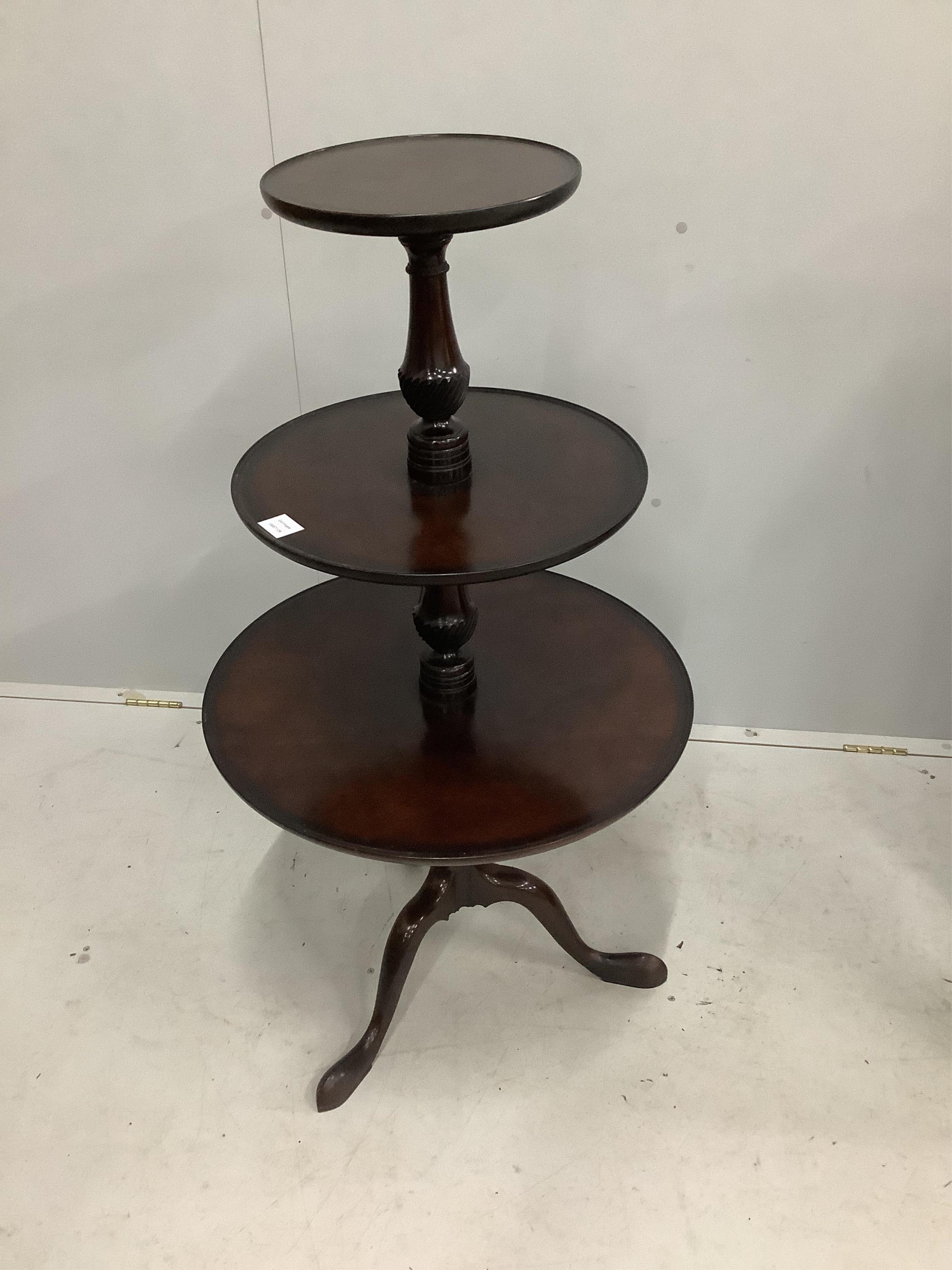 A George III style mahogany three tier dumb waiter, height 112cm. Condition - fair                                                                                                                                          