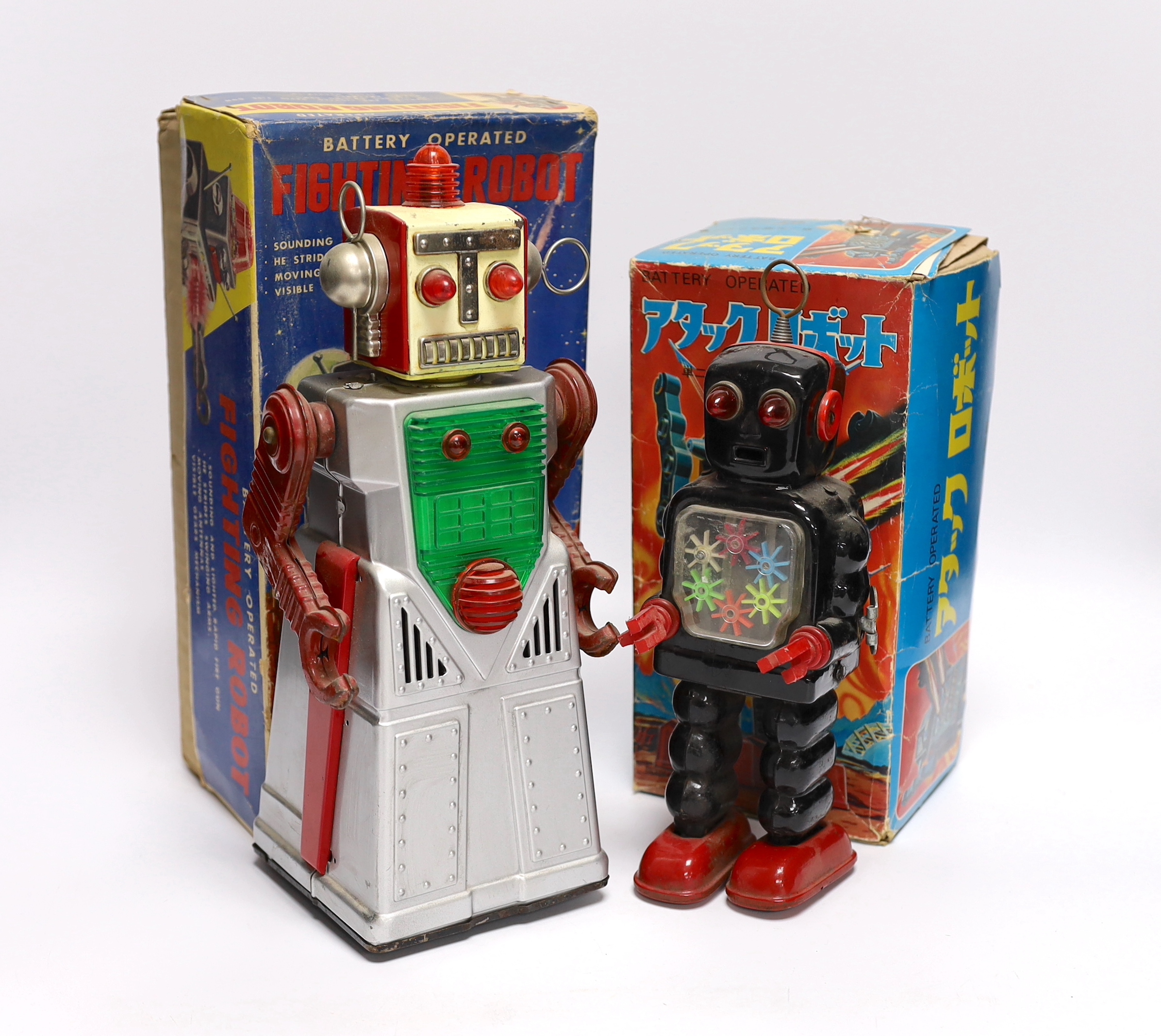 Four 1960s Japanese battery and clockwork powered robots, including; a boxed Horikawa (SH Toys) Fighting Robot, another smaller example by Horikawa, a Yoshiya (KO) silver robot and a Yoshhiya black clockwork robot, talle