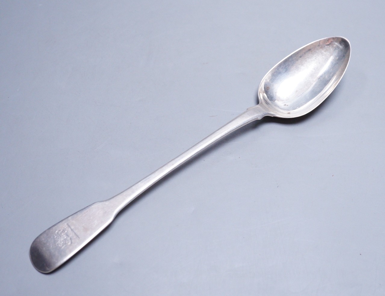 A George III silver fiddle pattern basting spoon, by Eley, Fearn & Chawner, London, 1811, 30.3cm, 124 grams, with engraved crest.                                                                                           