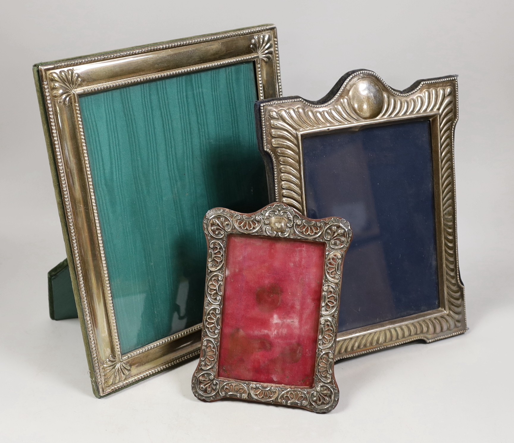 An Edwardian repousse silver mounted photograph frame, Birmingham, 1901, 19cm and two larger modern silver mounted photograph frames.                                                                                       