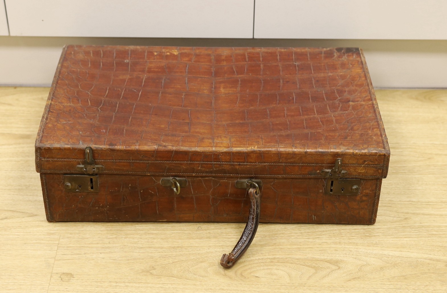 An early 20th Century crocodile skin suitcase - 60cm wide                                                                                                                                                                   