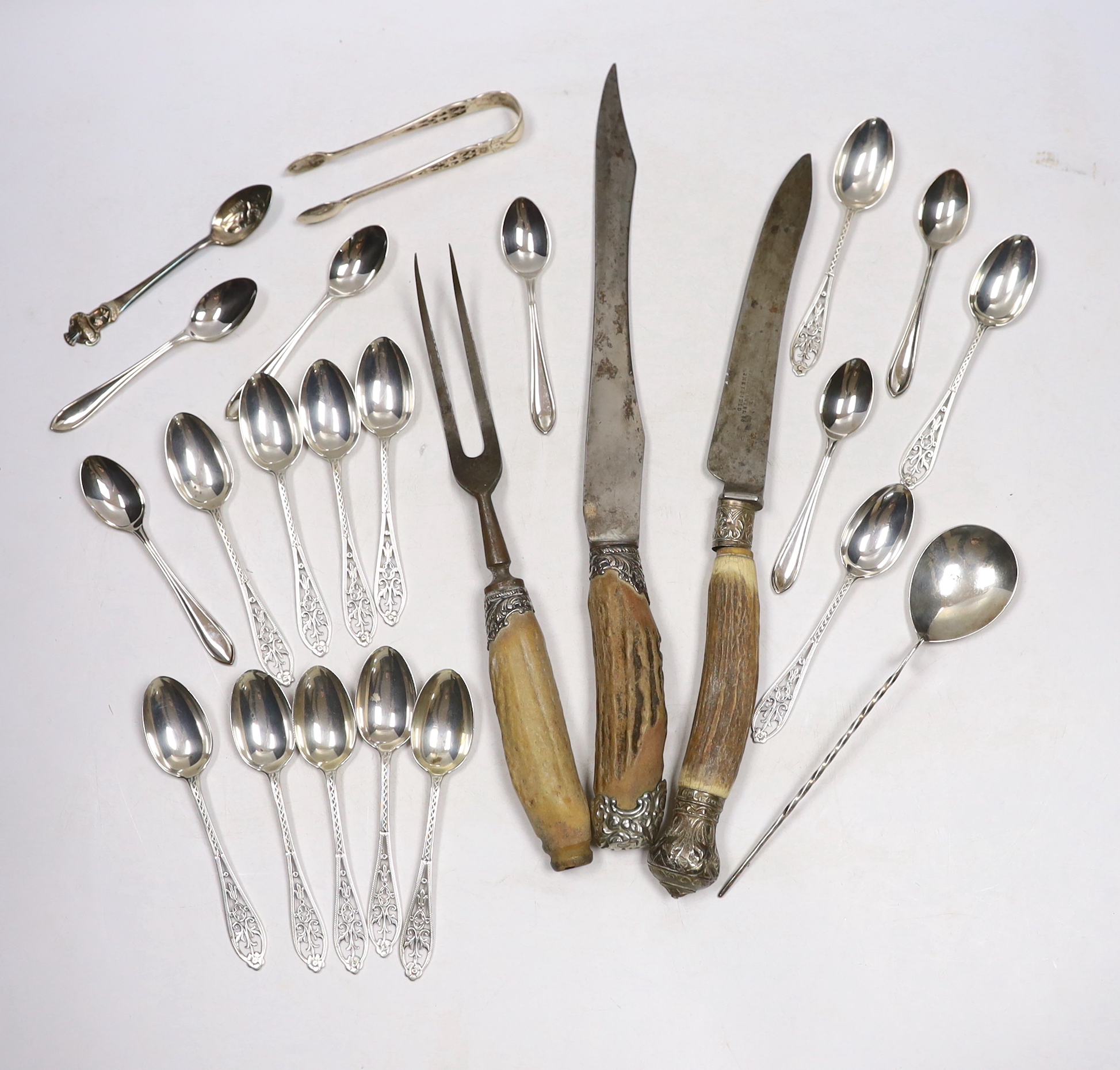 A set of twelve George V silver coffee spoons, with pierced handles, Josiah Williams & Co, London, 1912, 11.5cm, seven other silver spoons, a plated spoon and a three piece stag horn handled carving set.                 