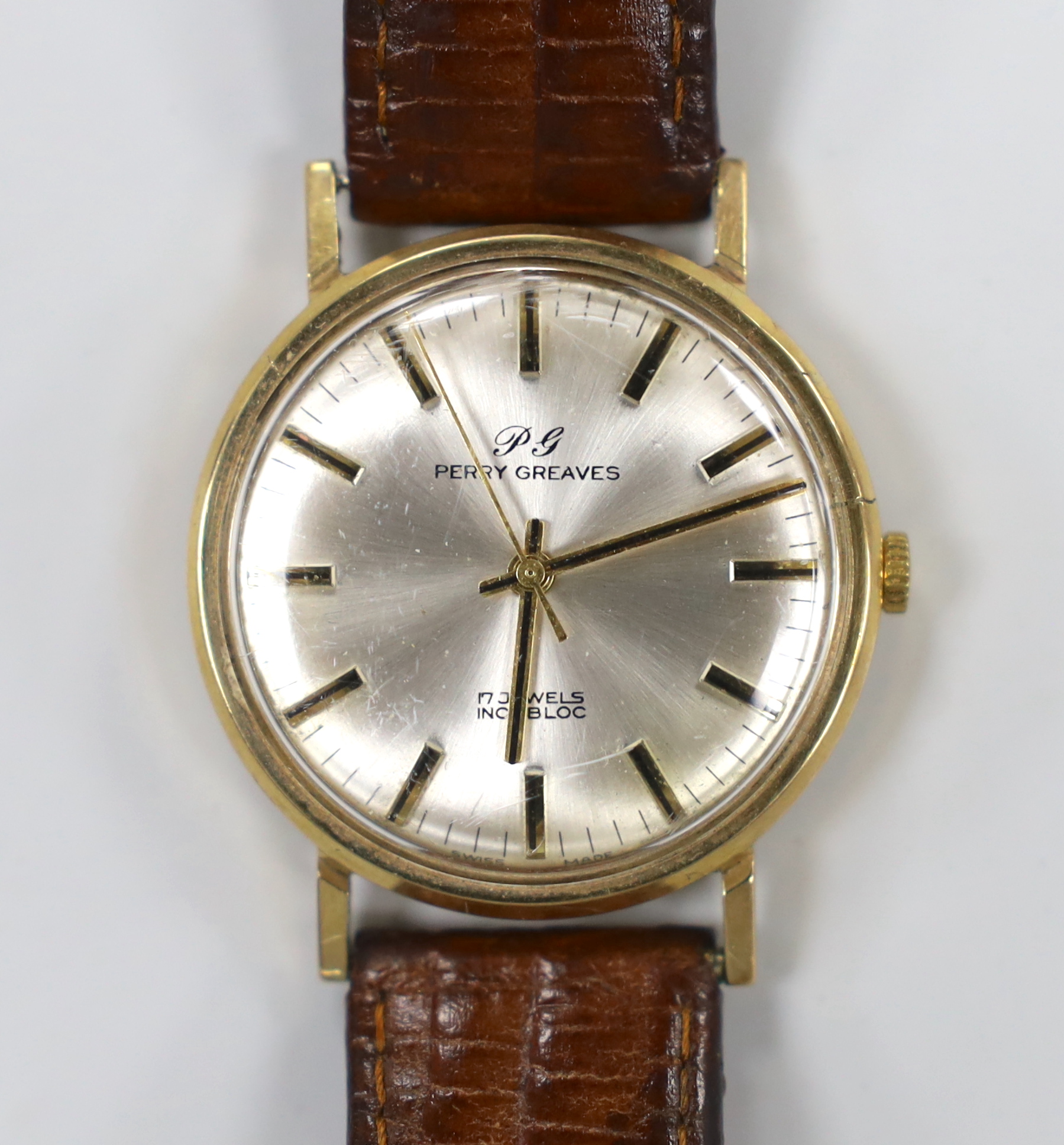 A gentleman's yellow metal Perry Greaves manual wind wrist watch, with case back inscription.                                                                                                                               