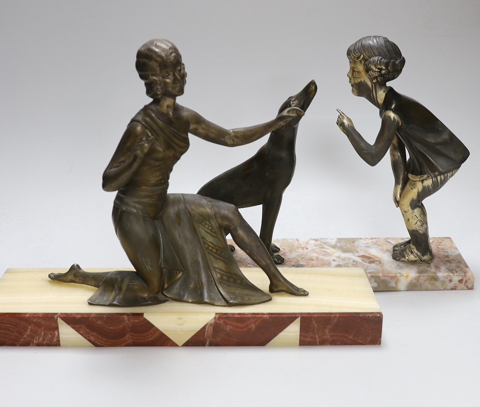 An Art Deco spelter figure of a girl and dog on marble base signed P.Sega, together with a similar Art deco figure of a female dancer on an onyx and red marble base, height 28cm                                           