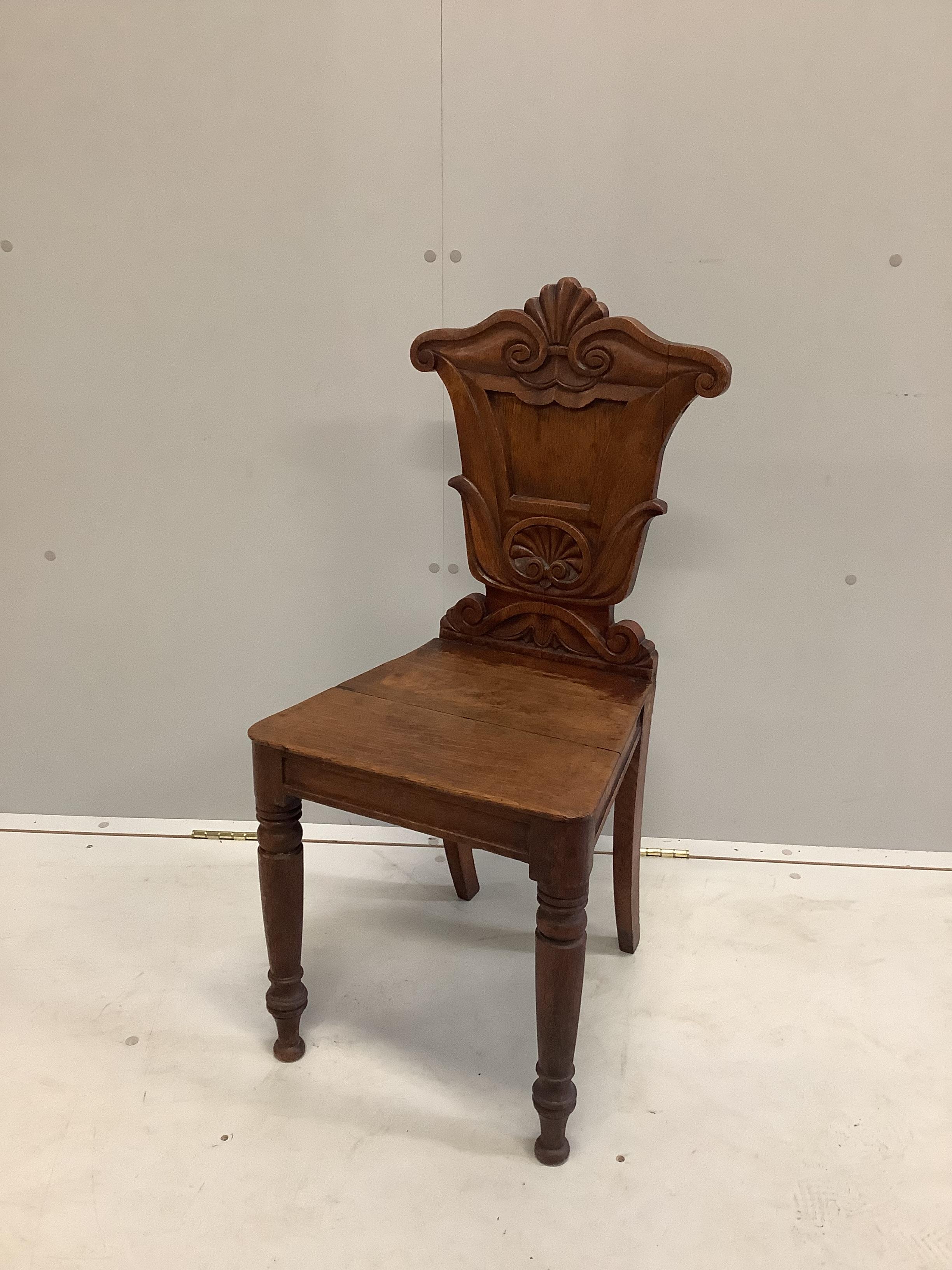 An early Victorian carved oak hall chair, width 40cm, depth 37cm, height 86cm                                                                                                                                               