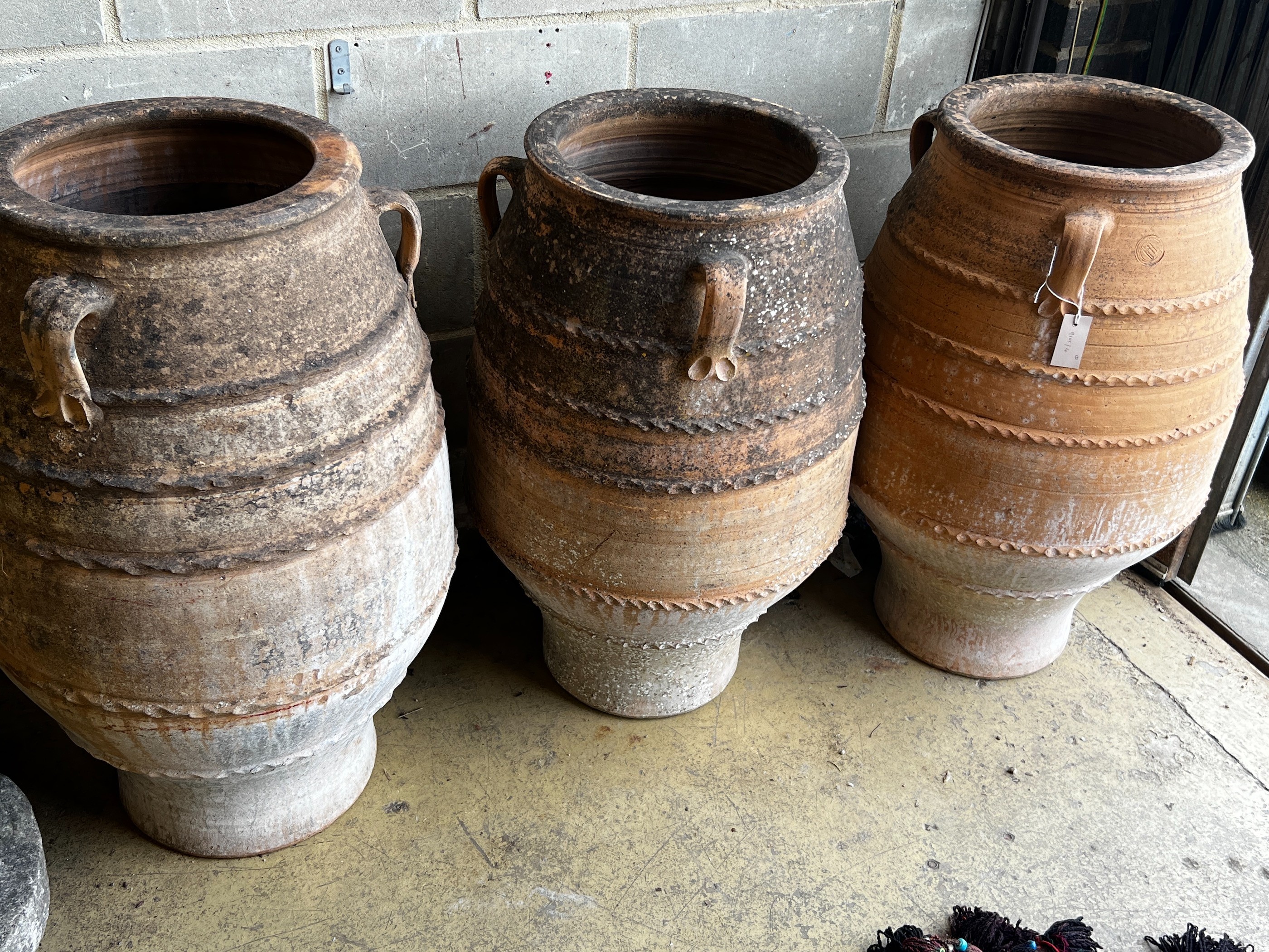 Three Greek terracotta oil jars, largest height 91cm                                                                                                                                                                        