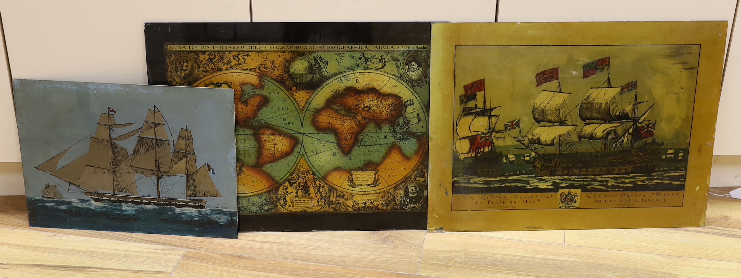 Three reverse painted glass panels, two of sailing ships and another map of the world- 62cm wide x 47cm high                                                                                                                