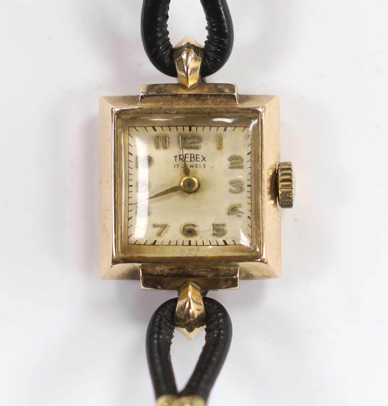 A lady's 9ct gold Trebex manual wind wrist watch, on a twin fabric strap.                                                                                                                                                   