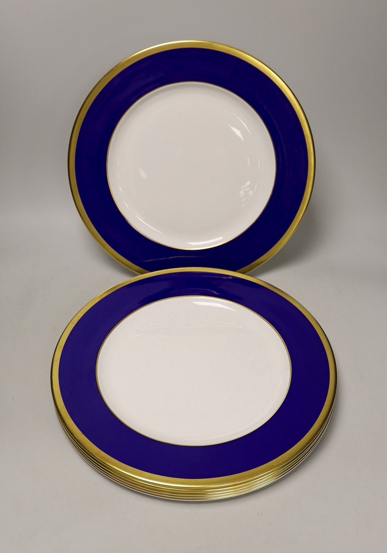 Six Asprey, London, blue and gilt banded dinner plates, 34cms diameter                                                                                                                                                      