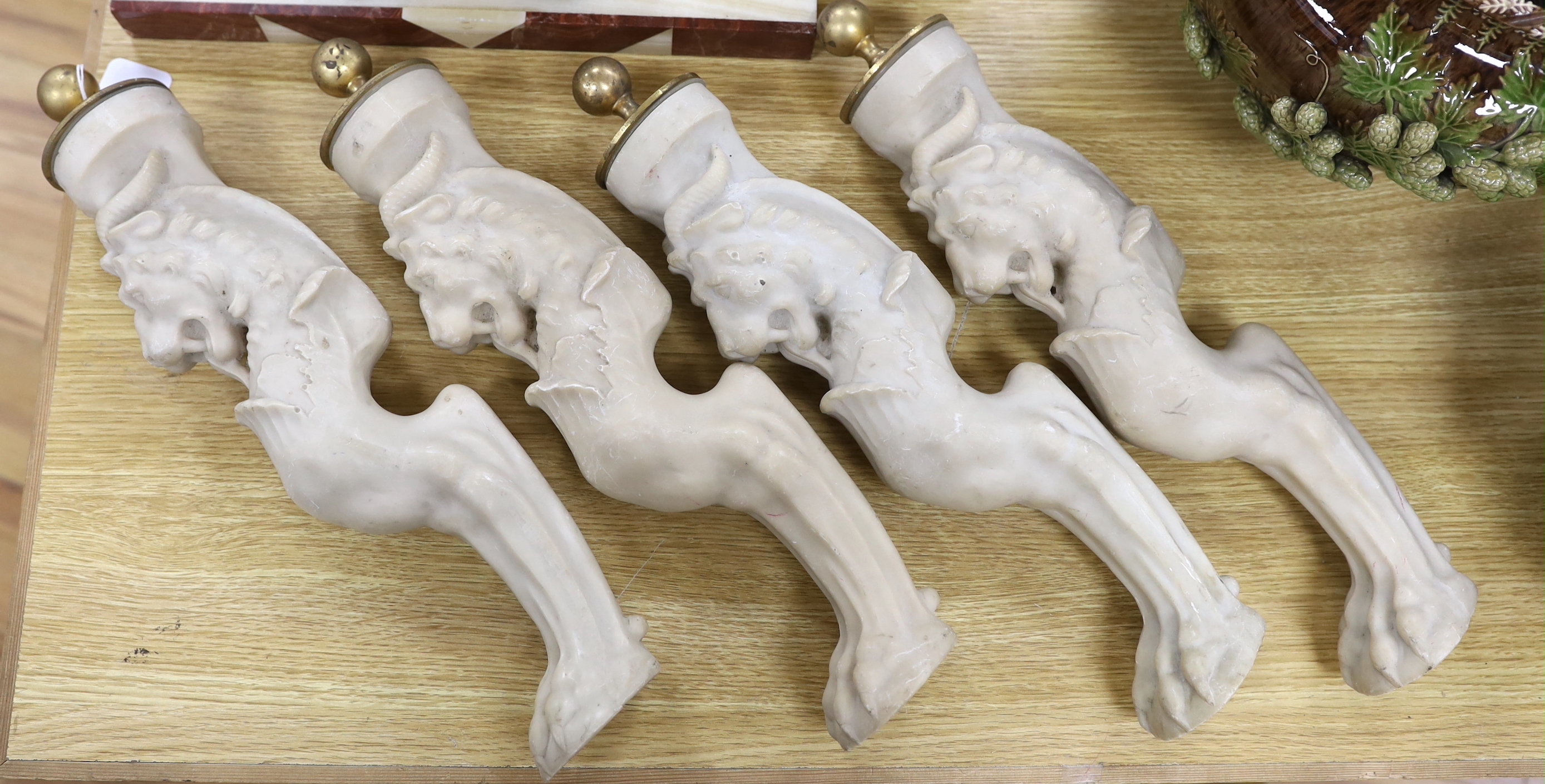 A set of four resin monopodia with brass caps, 44cm                                                                                                                                                                         