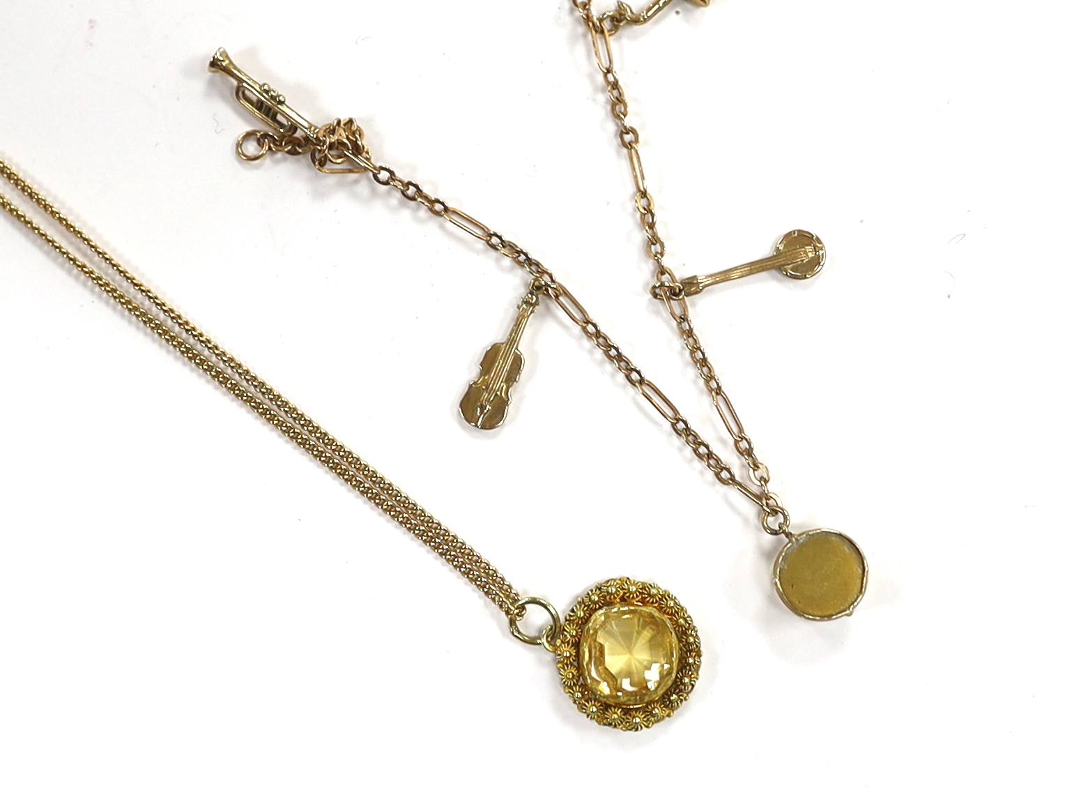 A small 9ct gold charm bracelet, hung with three assorted charms, gross weight 3 grams and a yellow metal and citrine set pendant on a 15ct chain, gross weight 5.5 grams.                                                  