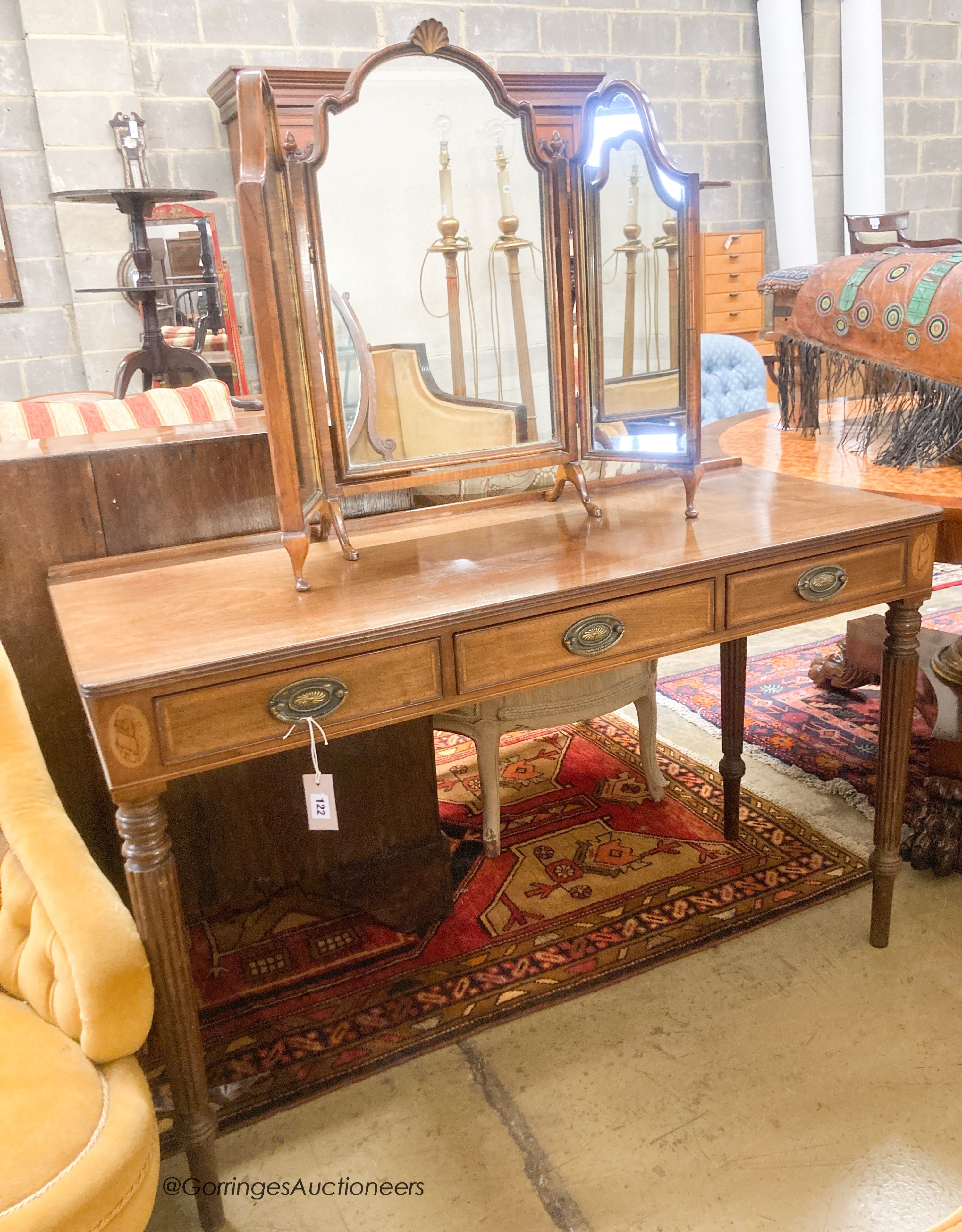 An early 20th century Georgian style mahogany dressing table, width 122cm, depth 49cm, height 77cm together with a Queen Anne style dressing table mirror                                                                   