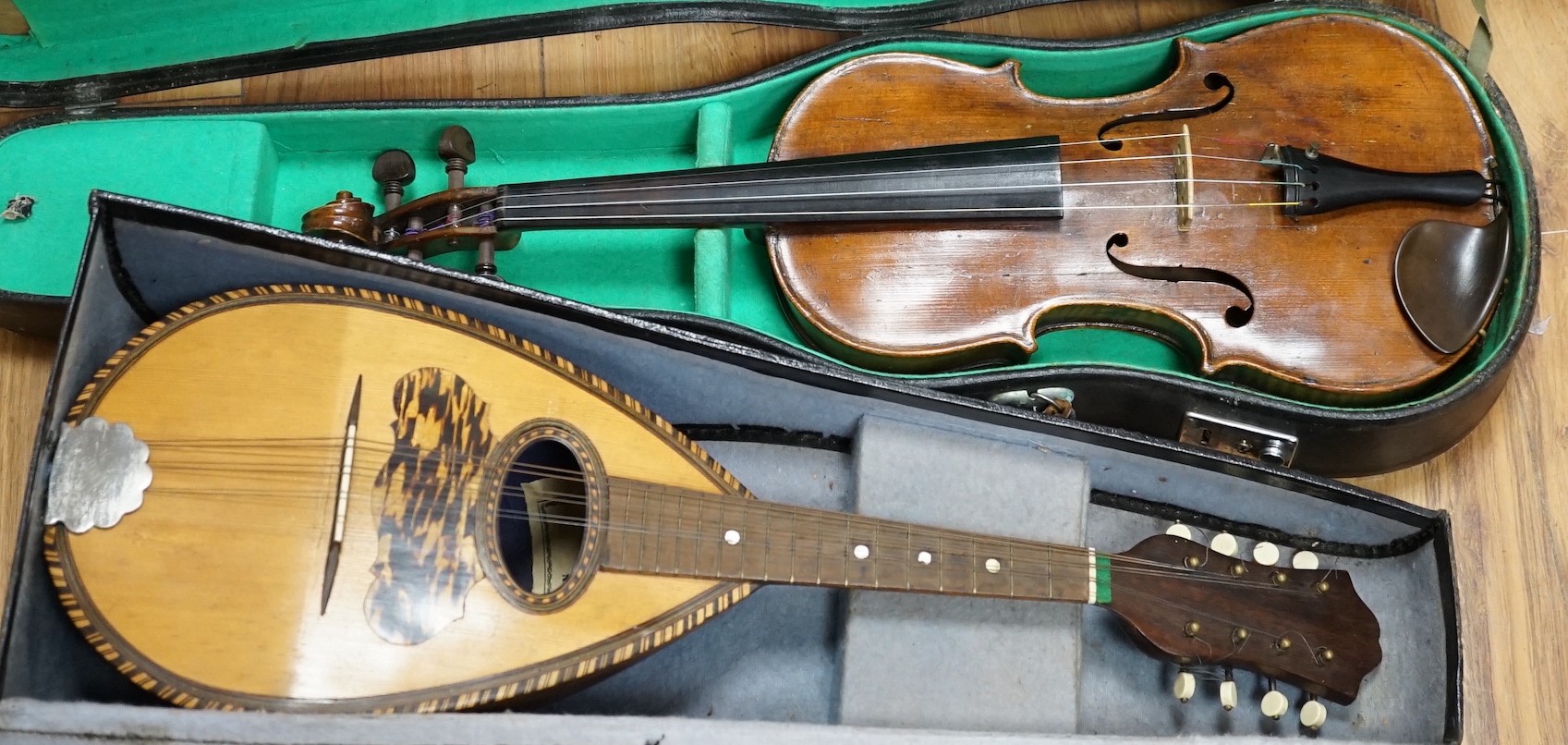 A late 19th century German violin together with an Italian mandolin, (both cased)                                                                                                                                           