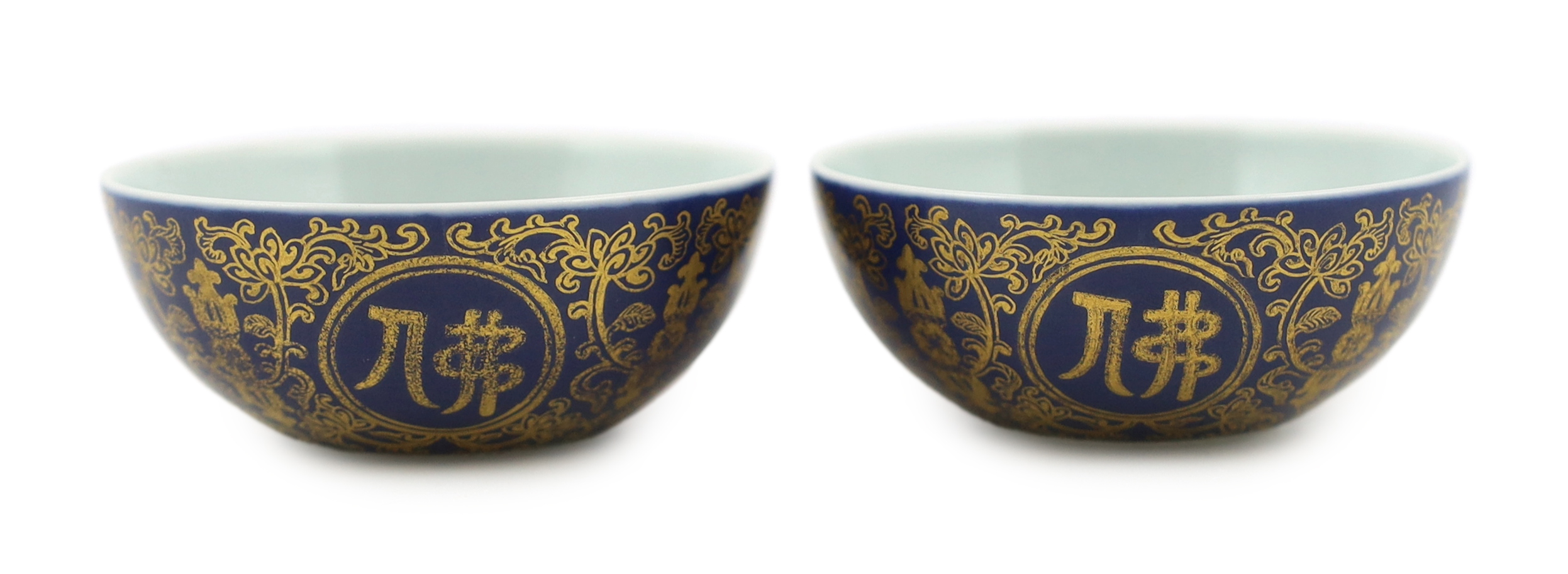 A pair of Chinese gilt decorated blue ground cups, Qianlong mark but later, one cracked                                                                                                                                     