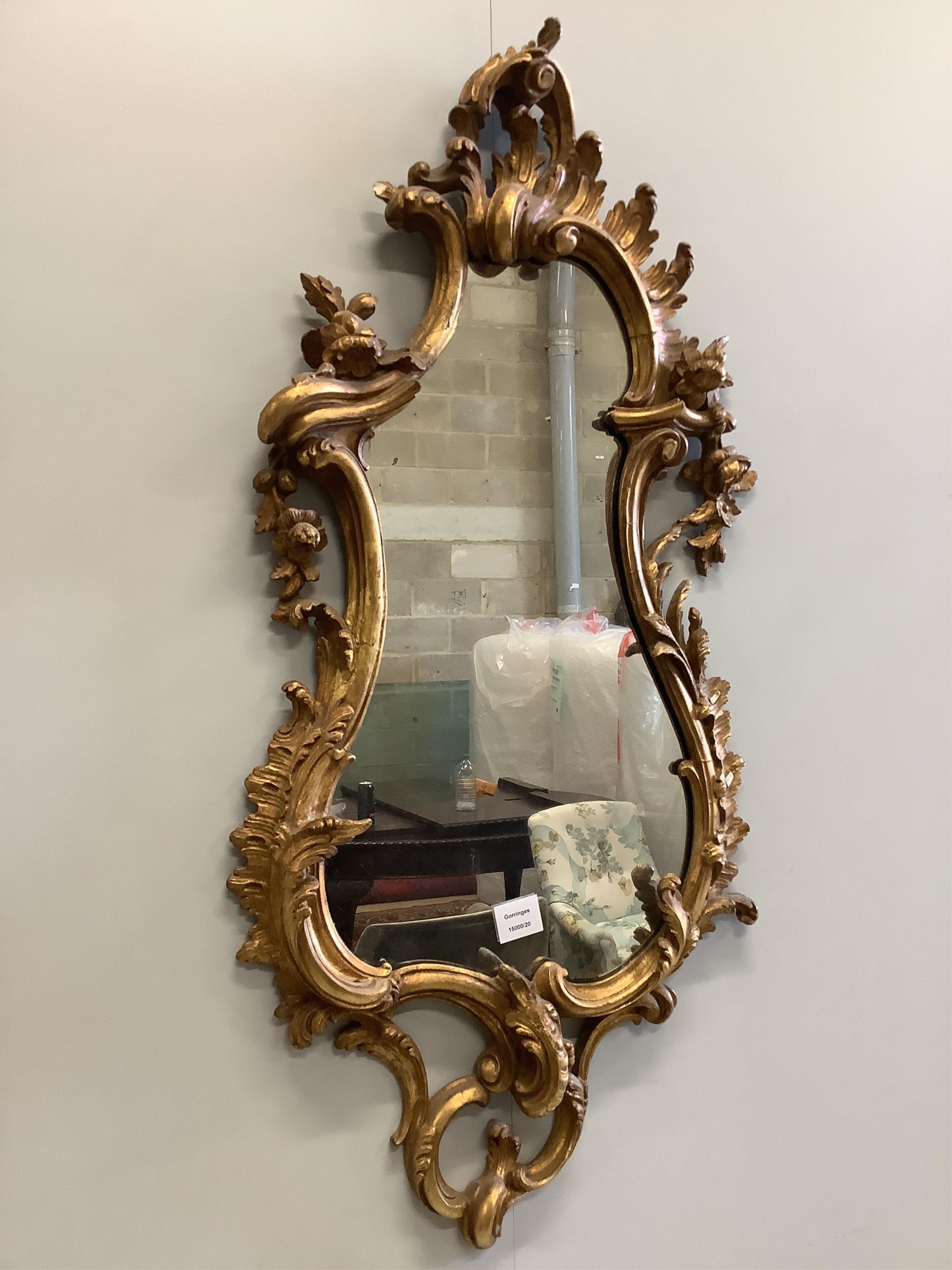 An 18th century style carved giltwood and composition asymmetrical wall mirror, width 48cm, height 100cm. Condition - good                                                                                                  