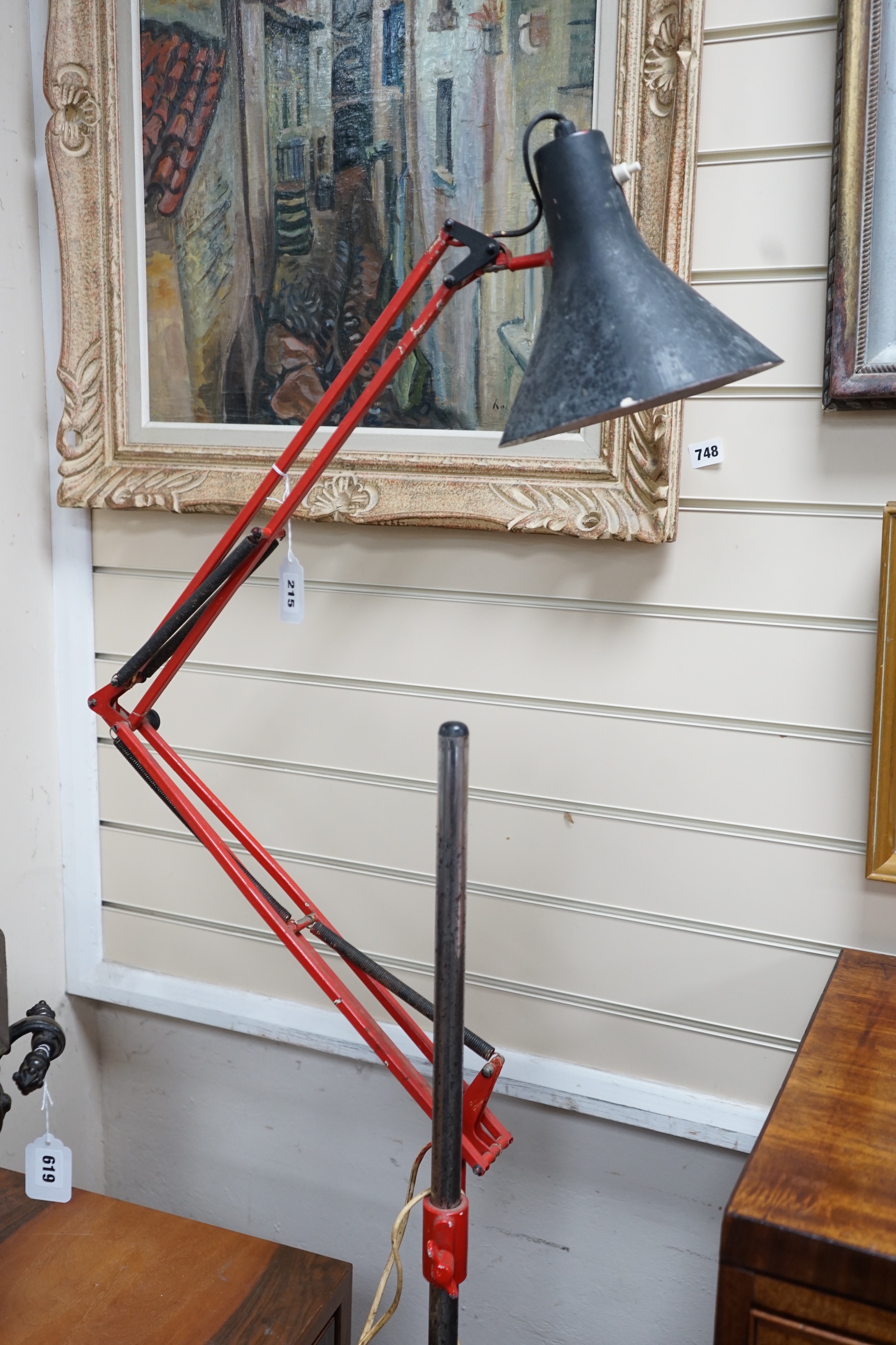 A converted industrial style anglepoise standard lamp on cast metal wheeled stand                                                                                                                                           