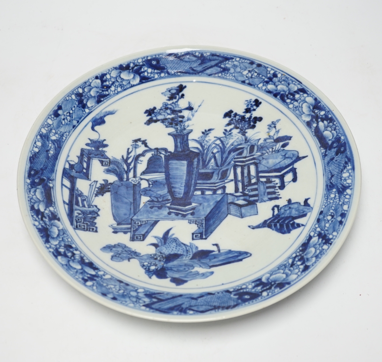 A 19th century Chinese blue and white ‘Hundred Antiques’ dish, with fish to the border, 30cm in diameter                                                                                                                    