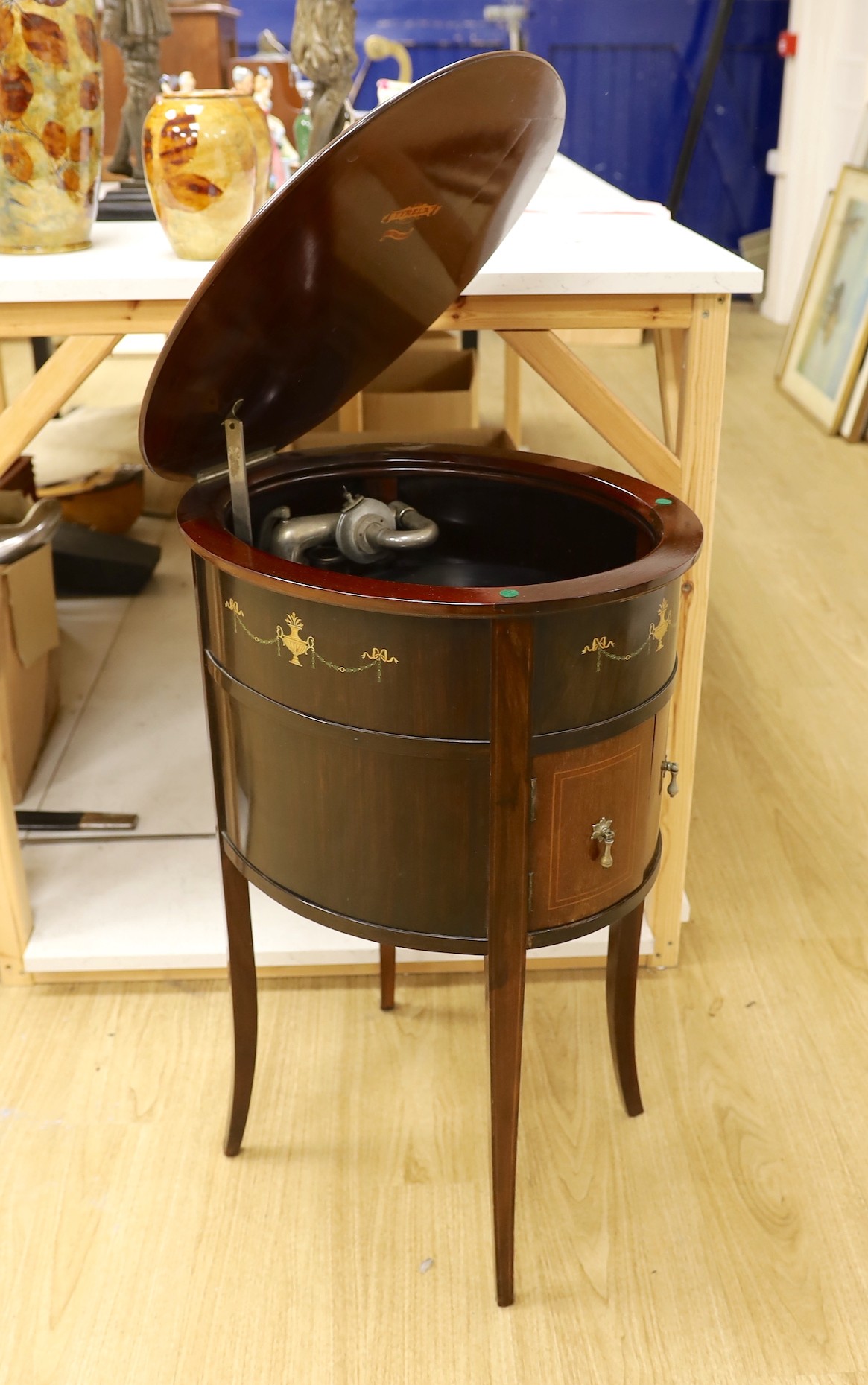 An early 20th century Tyrela parlour gramophone, in an oval mahogany table cabinet, 51 cm wide, 77 cm high                                                                                                                  