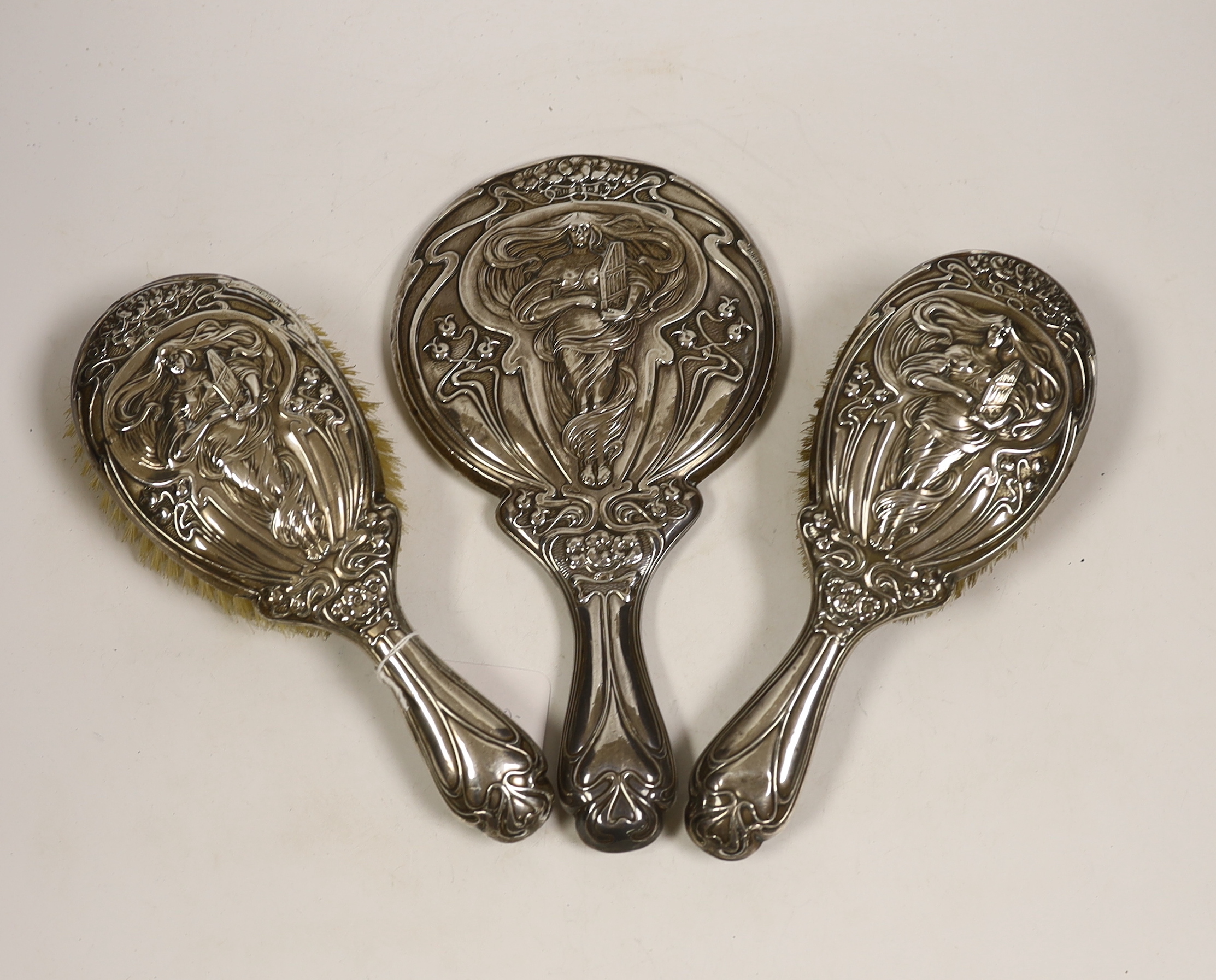 An Edwardian Art Nouveau silver mounted hand mirror and hair brush, maker Charles Horner?, Birmingham, 1906/7 and a similar hair brush, W.G. Keight & Co, Birmingham, 1905.                                                 