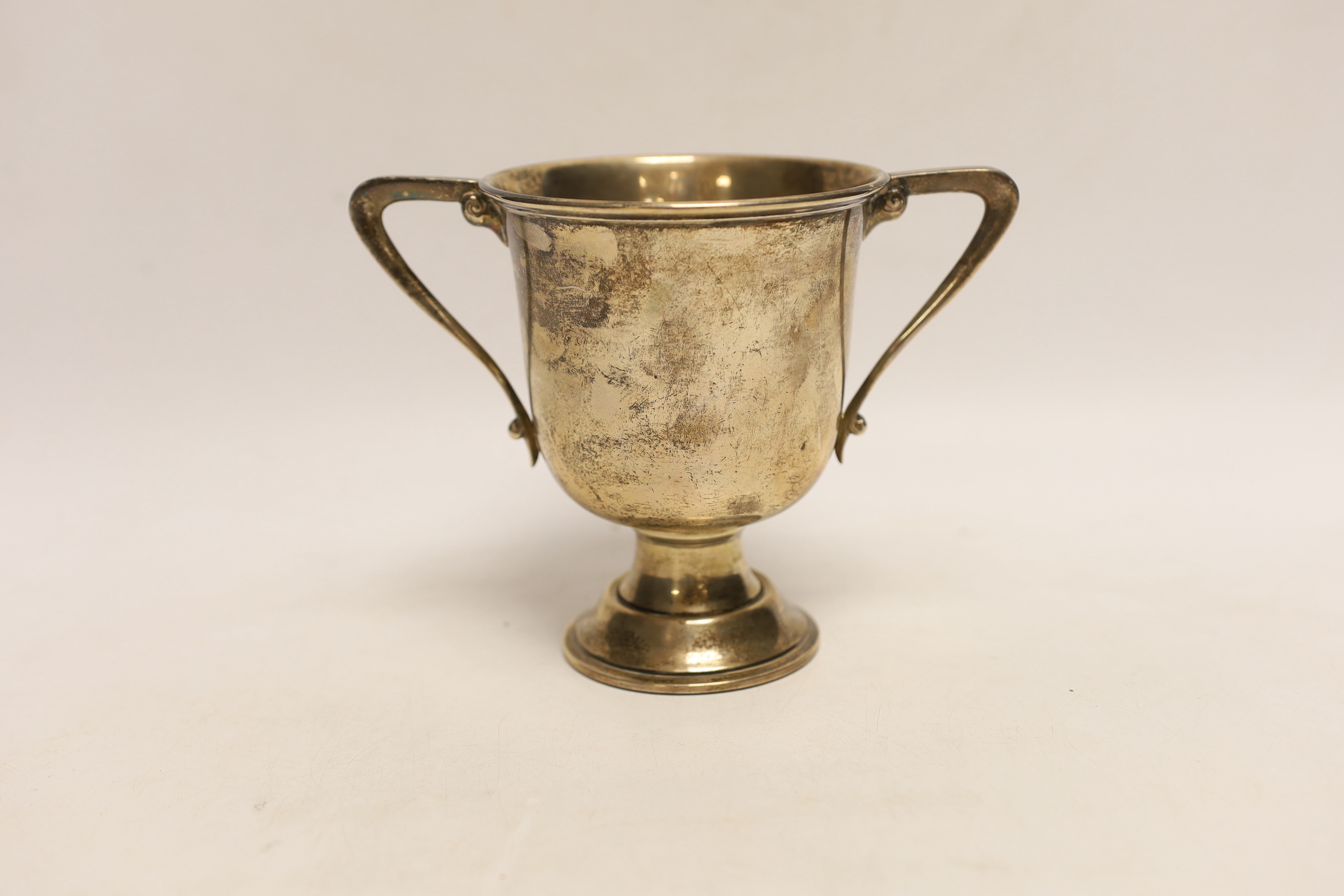 A George V silver two handled trophy cup, Charles Edwards, London, 1921, 12.2cm, 8.4oz.                                                                                                                                     