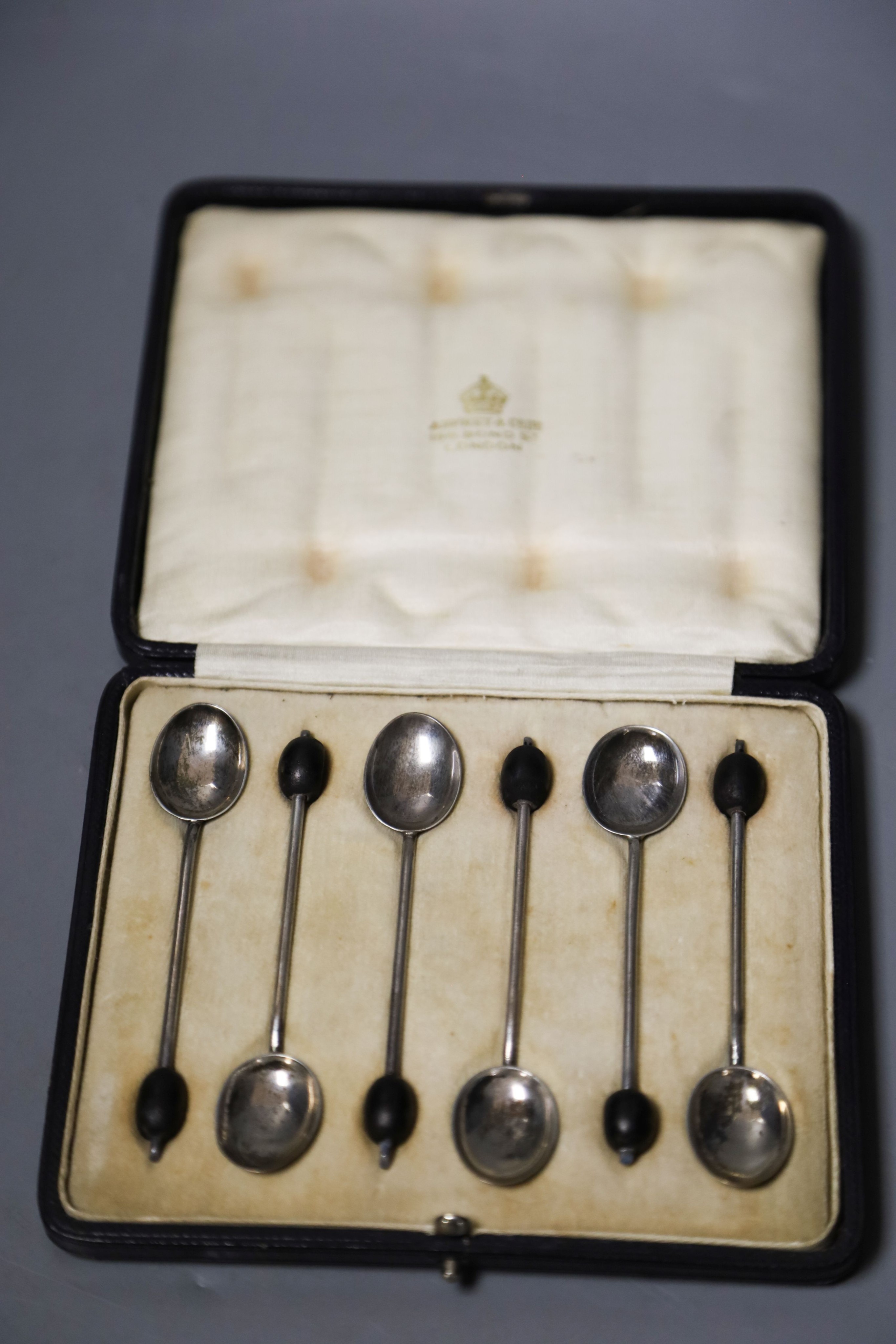 A cased set of six George V silver bean end coffee spoons                                                                                                                                                                   