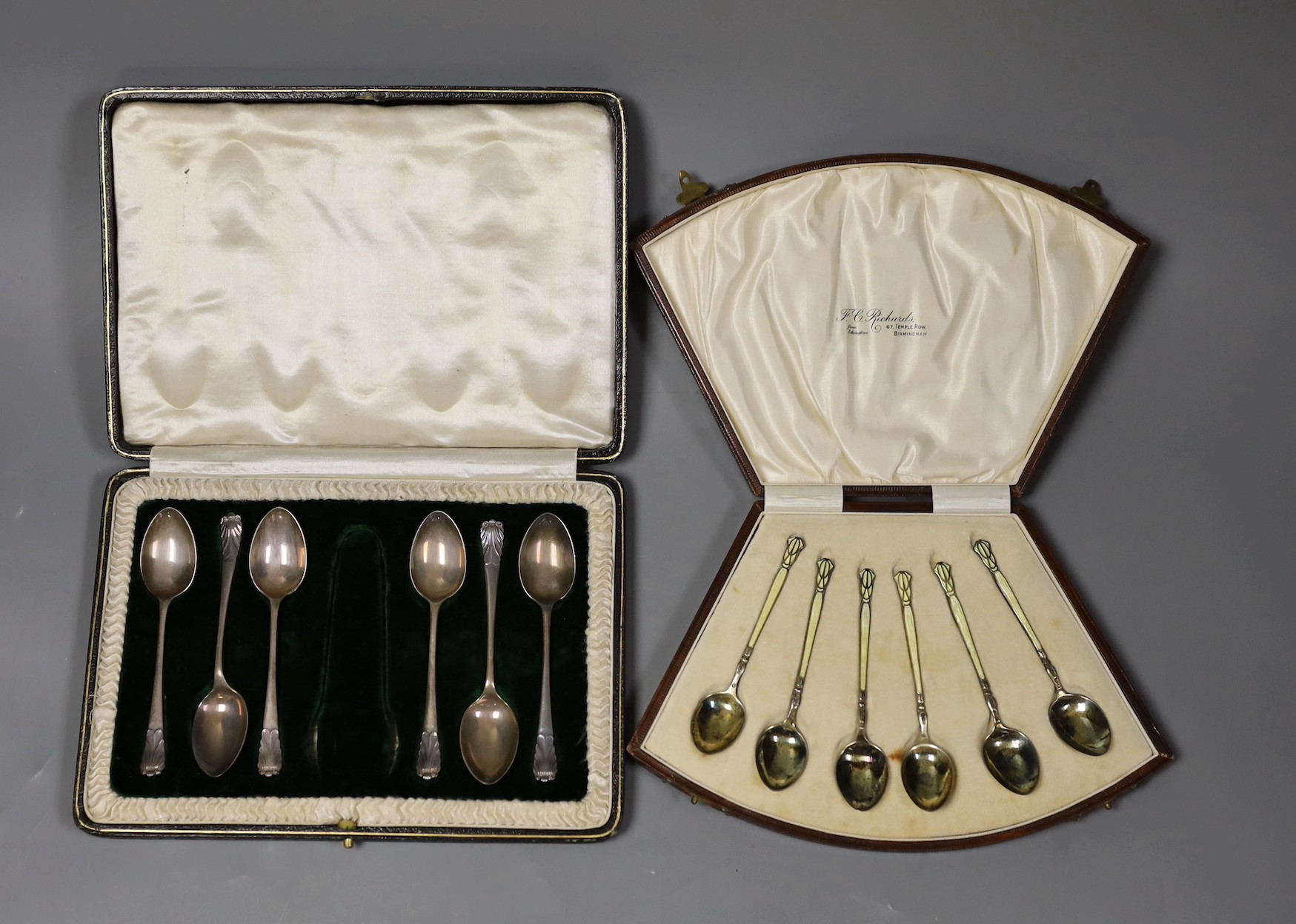 A cased set of six George V silver and enamel coffee spoons, Henry Clifford Davis, Birmingham, 1927, 95mm and a similar set of six silver coffee spoons.                                                                    