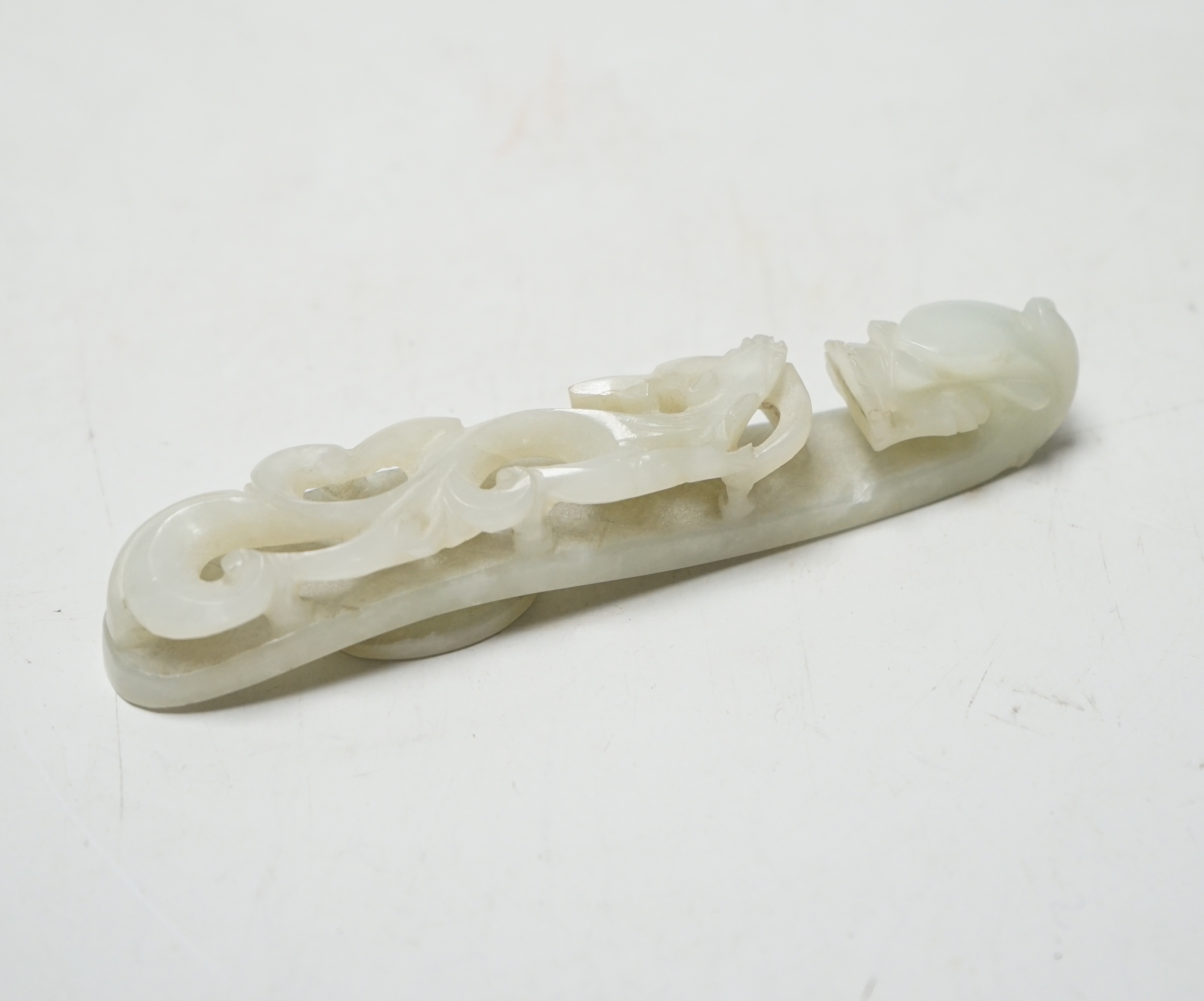 A Chinese pale celadon jade belthook, 19th century, 9.8cm                                                                                                                                                                   