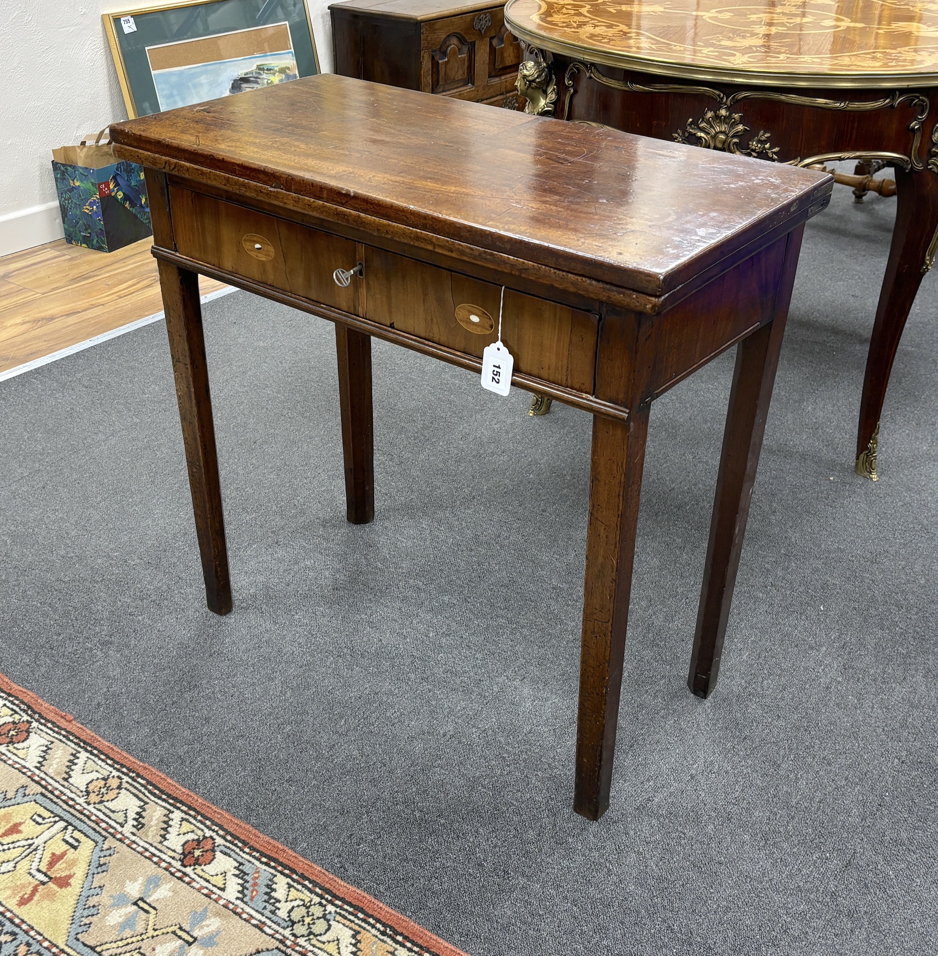 A George III rectangular mahogany folding tea table, width 75cm, depth 37cm, height 72cm.                                                                                                                                   