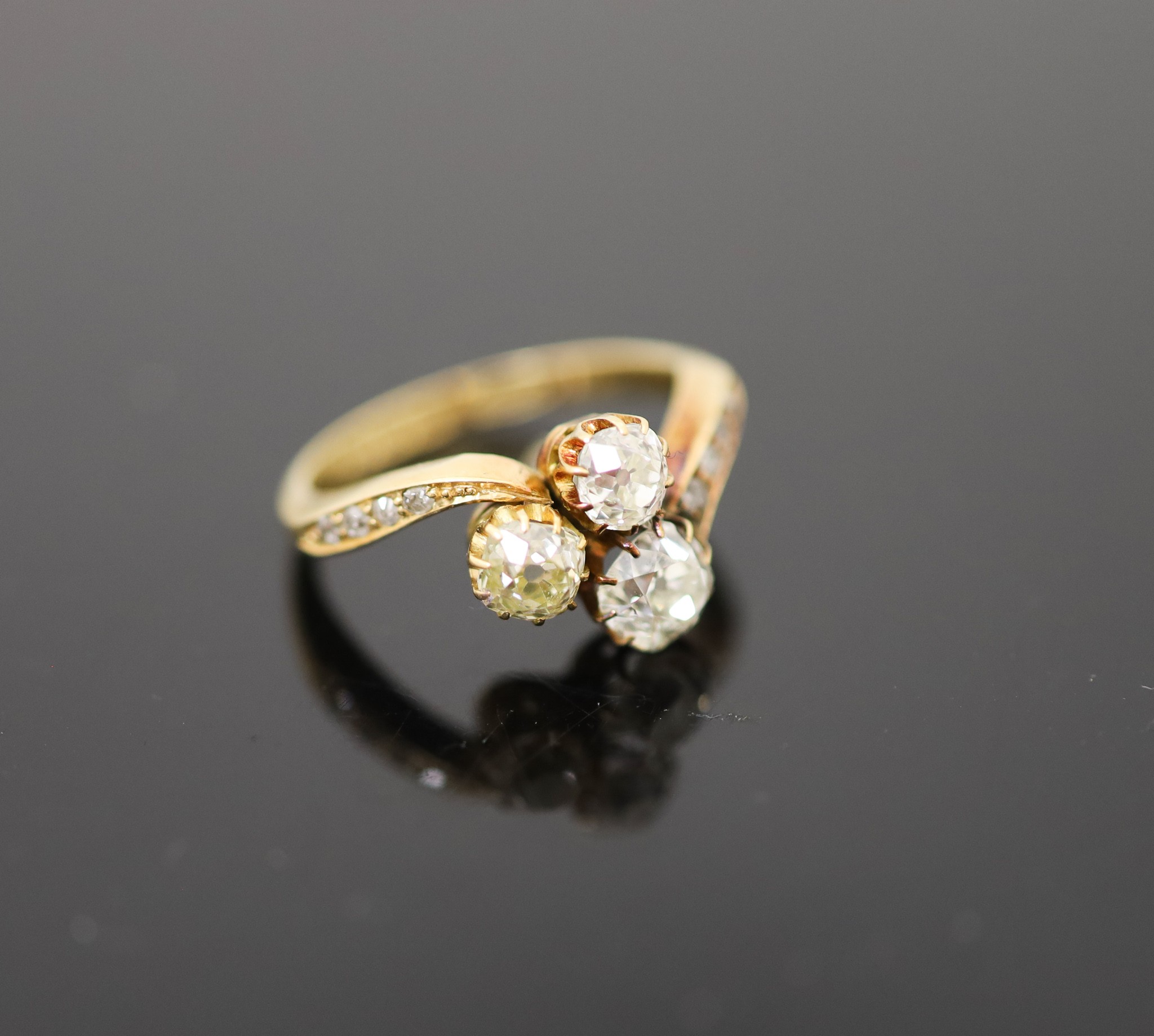 An Edwardian 18ct gold and three stone set clover shaped cluster ring                                                                                                                                                       