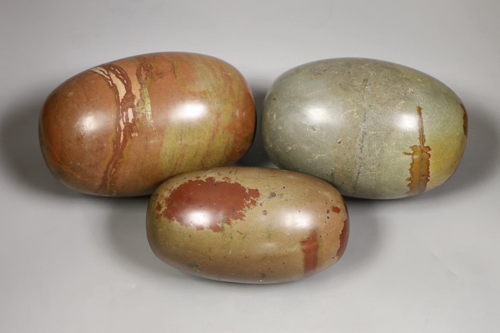 Three large polished jasper ovoid stones                                                                                                                                                                                    