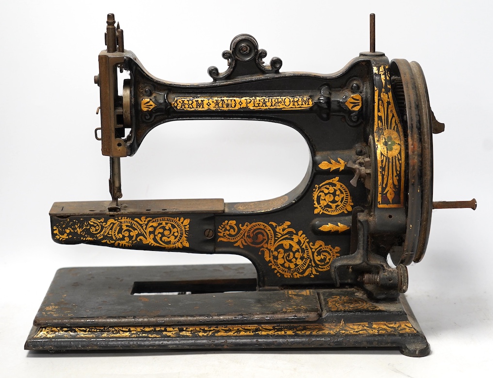 An 1870's Edward Ward sewing machine and a cast iron base with gilt decoration and maker’s marks. Condition - fair                                                                                                          