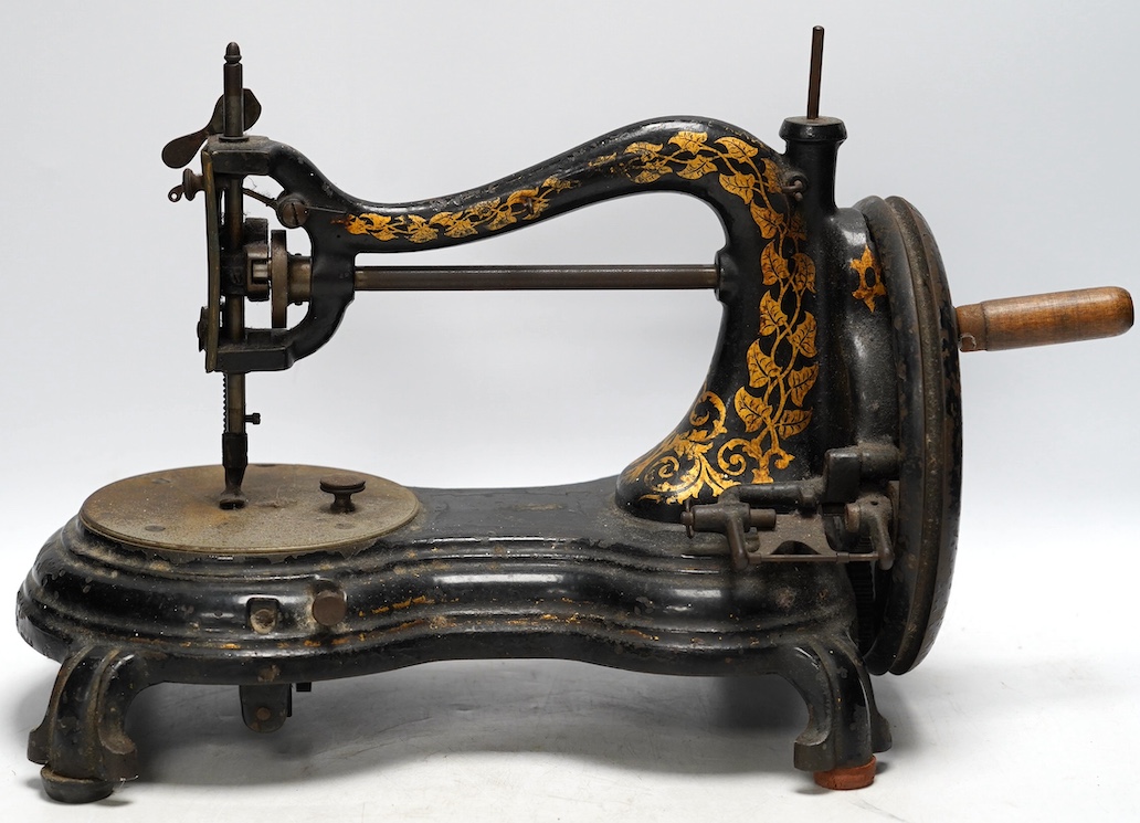 A late 19th century Jones swan neck sewing machine, with cast iron base and gilt ivy decoration to the frame. Condition - fair                                                                                              