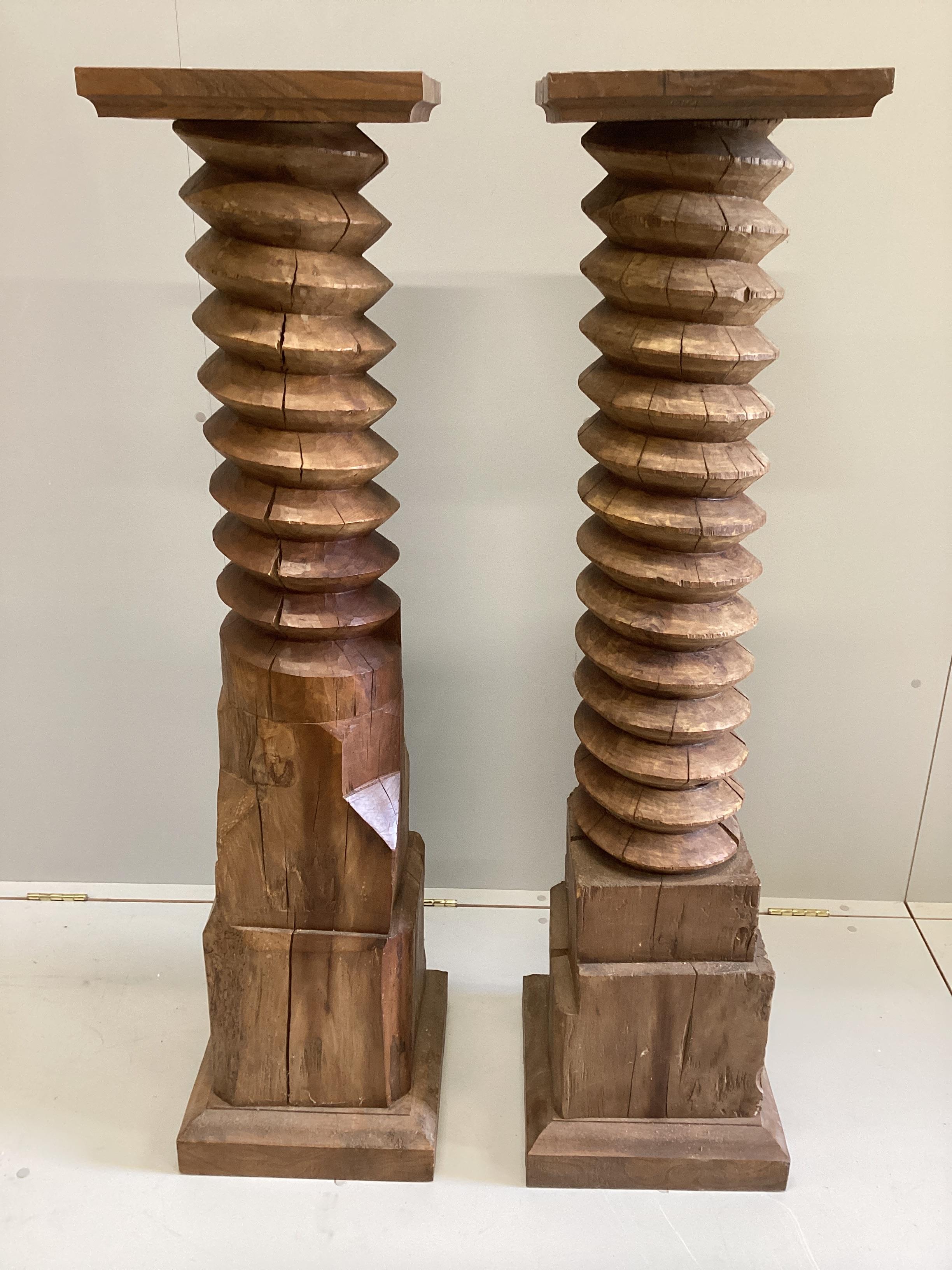 A near pair of French cider press thread pedestals, height 135cm                                                                                                                                                            
