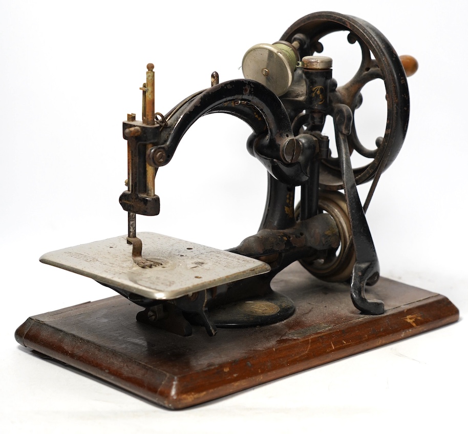 A late 19th century Wilcox and Gibbs sewing machine on a mahogany base. Condition - fair                                                                                                                                    