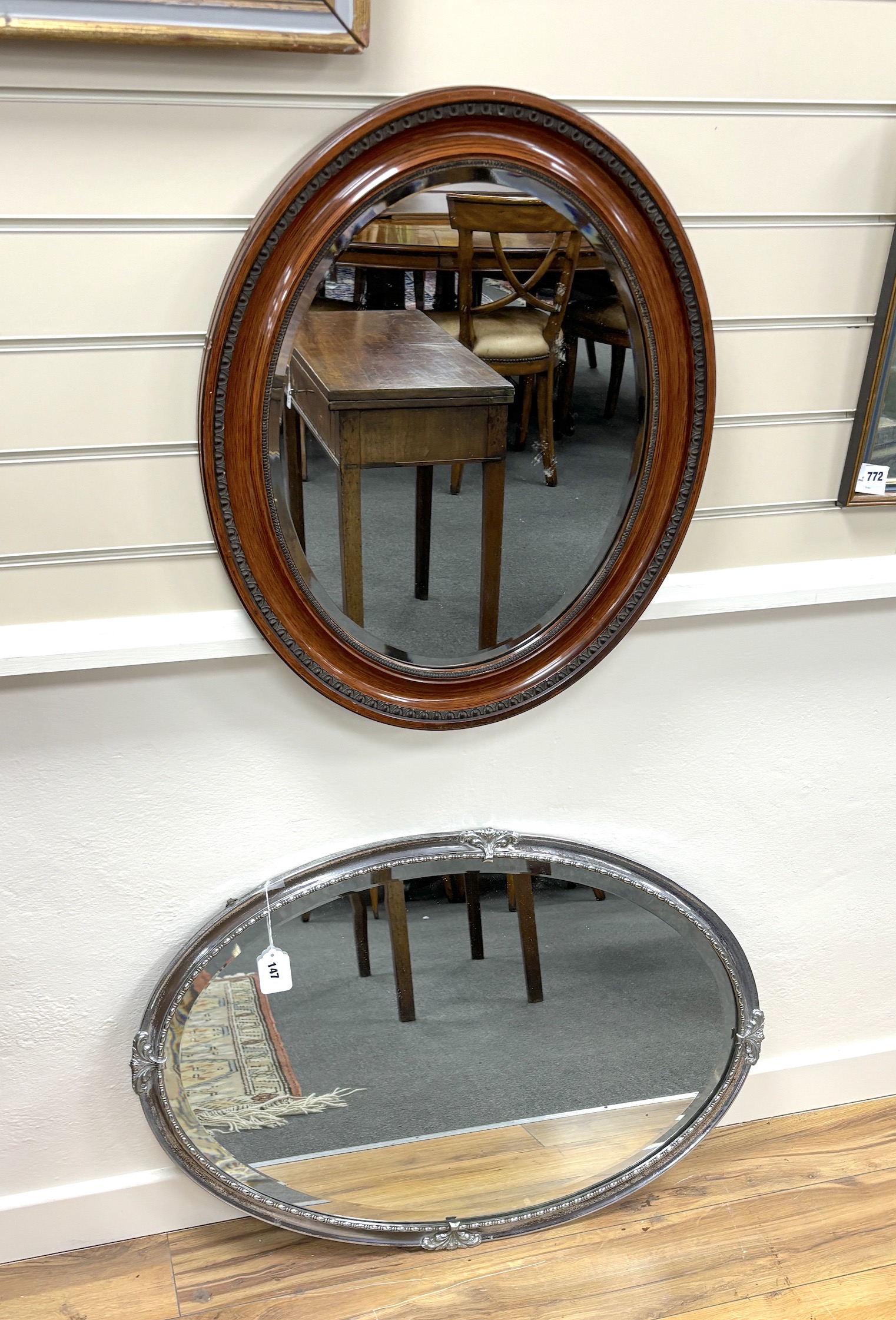 An early 20th century oval mirror, width 62cm and an early 20th century oval mirror, nickel plated frame and bevelled plate, 82cm                                                                                           