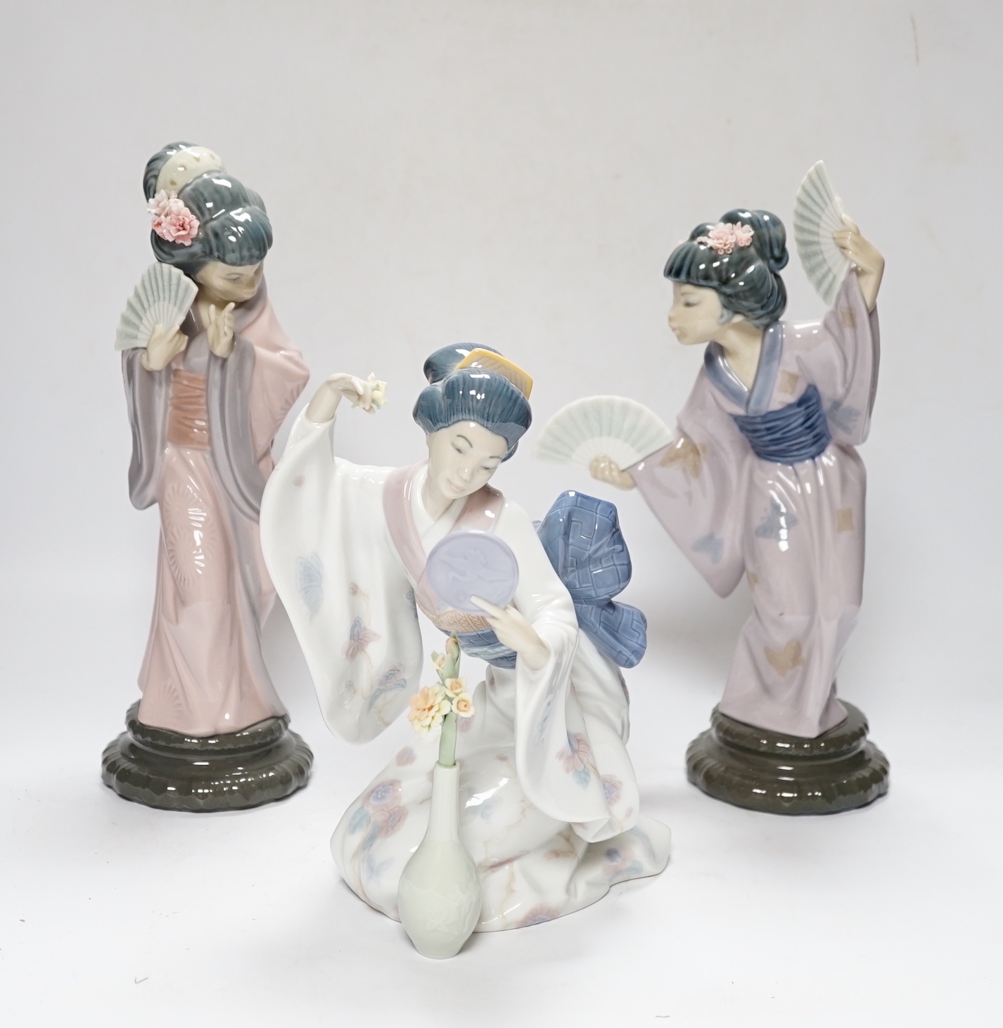 Three Lladro figures, Mirror Mirror, and two Japanese Geisha girls holding fans, (one boxed) tallest 29cm high                                                                                                              