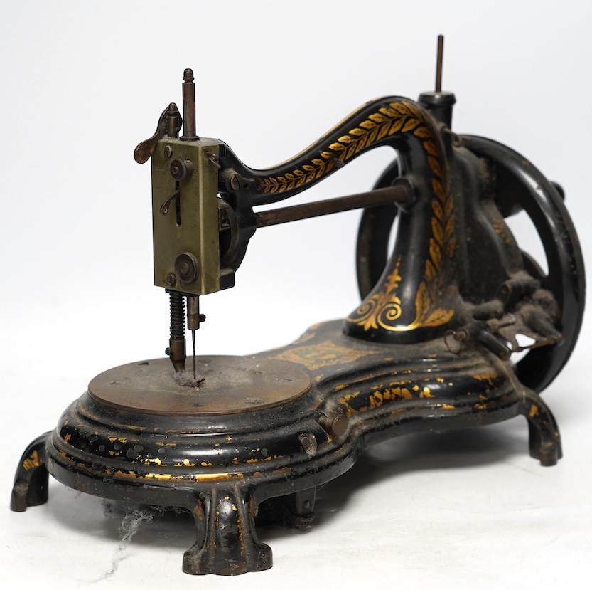 A late 19th century Jones swan neck sewing machine, with cast iron base and gilt decorated frame. Condition - fair                                                                                                          