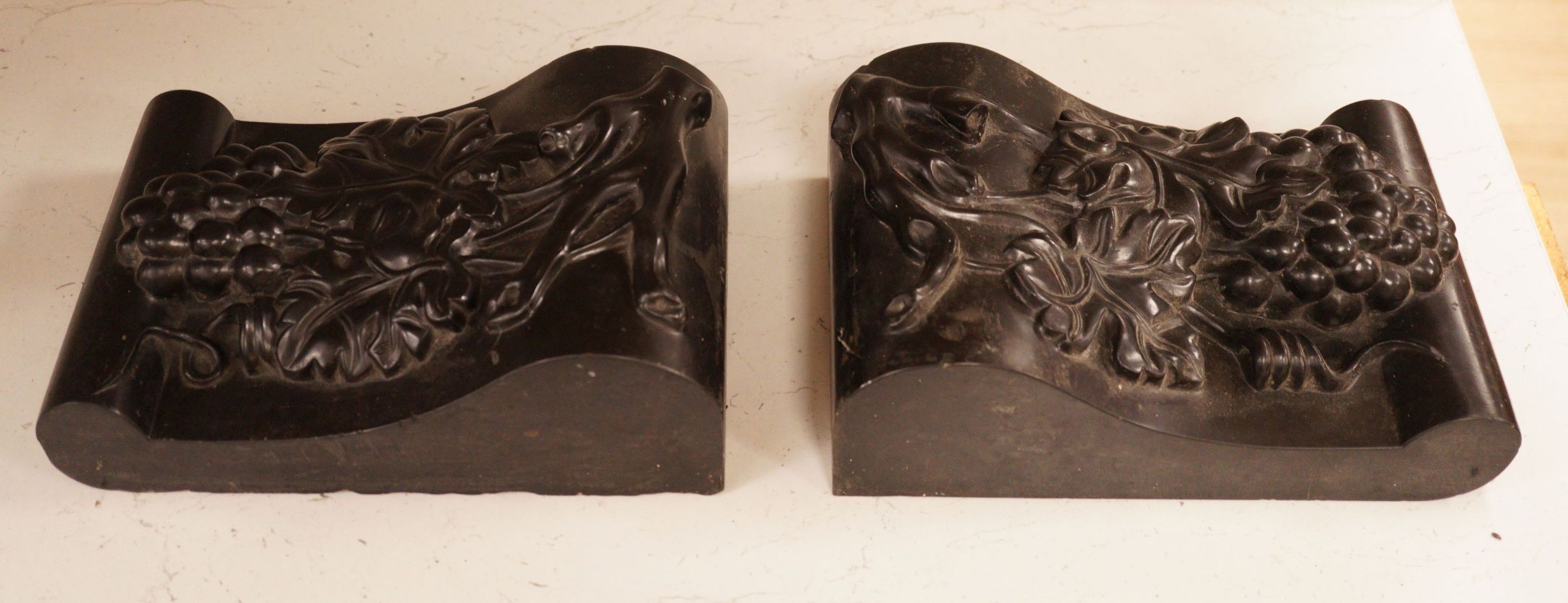 A pair of carved black marble corbels, fruiting vines, 24x17cm                                                                                                                                                              