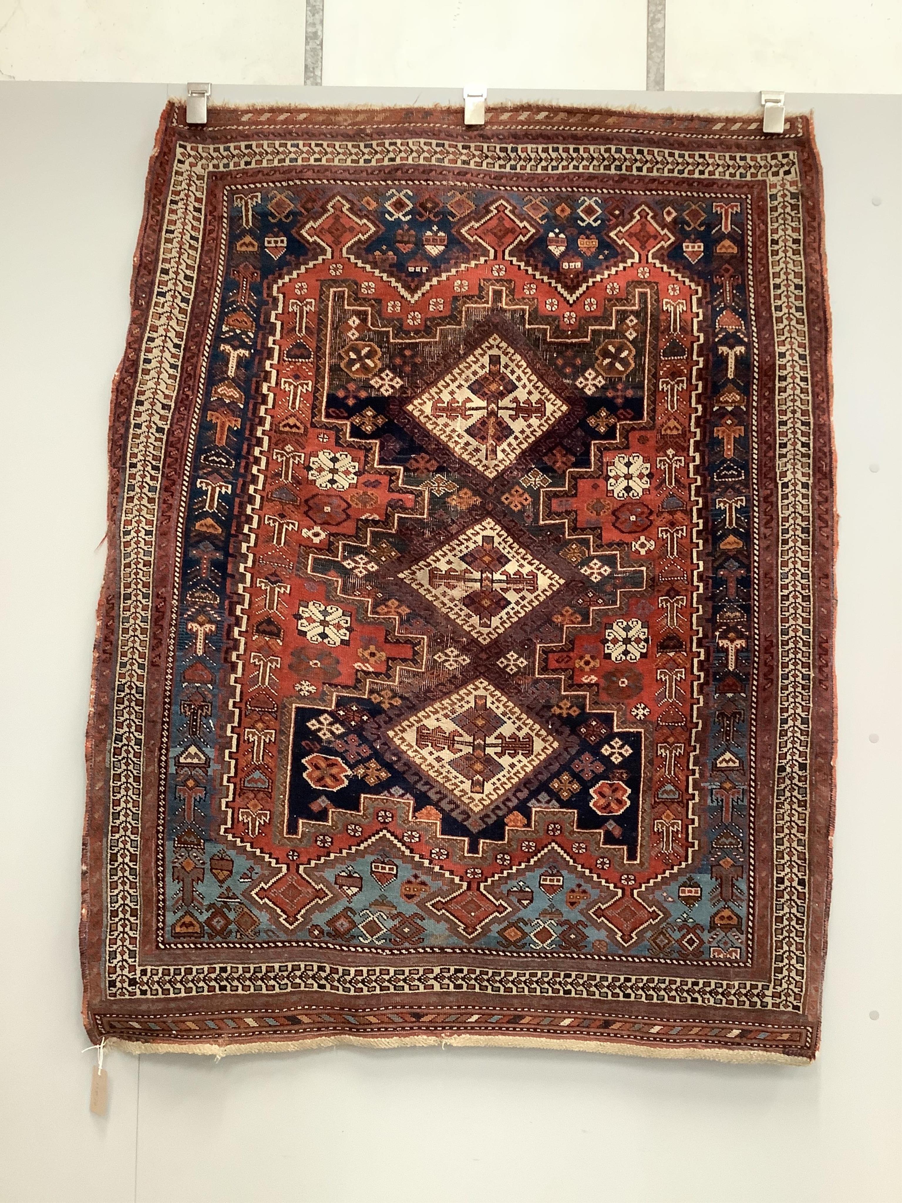 A Caucasian red ground rug, 150 x 118cm. Condition - worn in centre and a little faded, further wear around the edges                                                                                                       