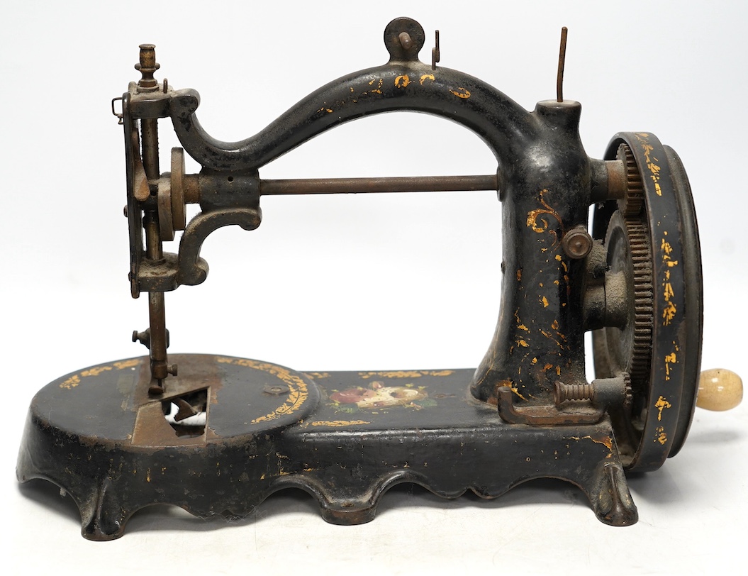 An unmarked late 19th century swan neck sewing machine, with cast iron base and gilt and floral decoration. Condition - fair                                                                                                